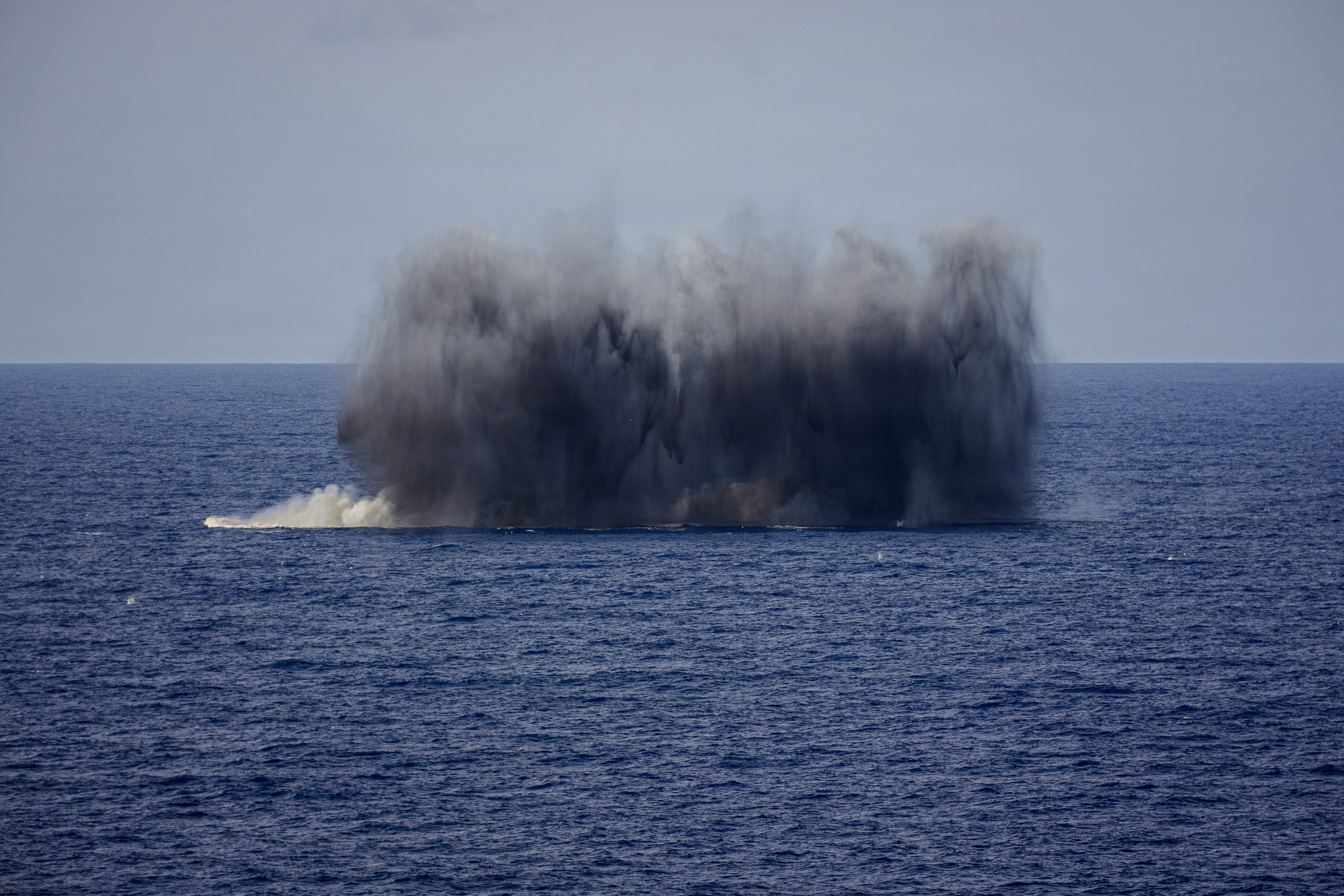 A MK12/BLU-111 aircraft bomb hits a simulated target during an air power demonstration over the Gulf of America, June 11, 2026. U.S. military forces are deployed to the U.S. Southern Command area of responsibility in support of Department of War-directed operations, and the president's priorities to disrupt illicit drug trafficking, deter malign actors and protect the homeland through continuous presence. Nimitz-class aircraft carriers are the pinnacle of mobile naval air power projection and forward operational presence. No other weapons system possesses the responsiveness, endurance, multi-dimensional might, inherent battlespace awareness, and command and control capabilities of a carrier strike group and its embarked air wing. (U.S. Navy photo / Released)