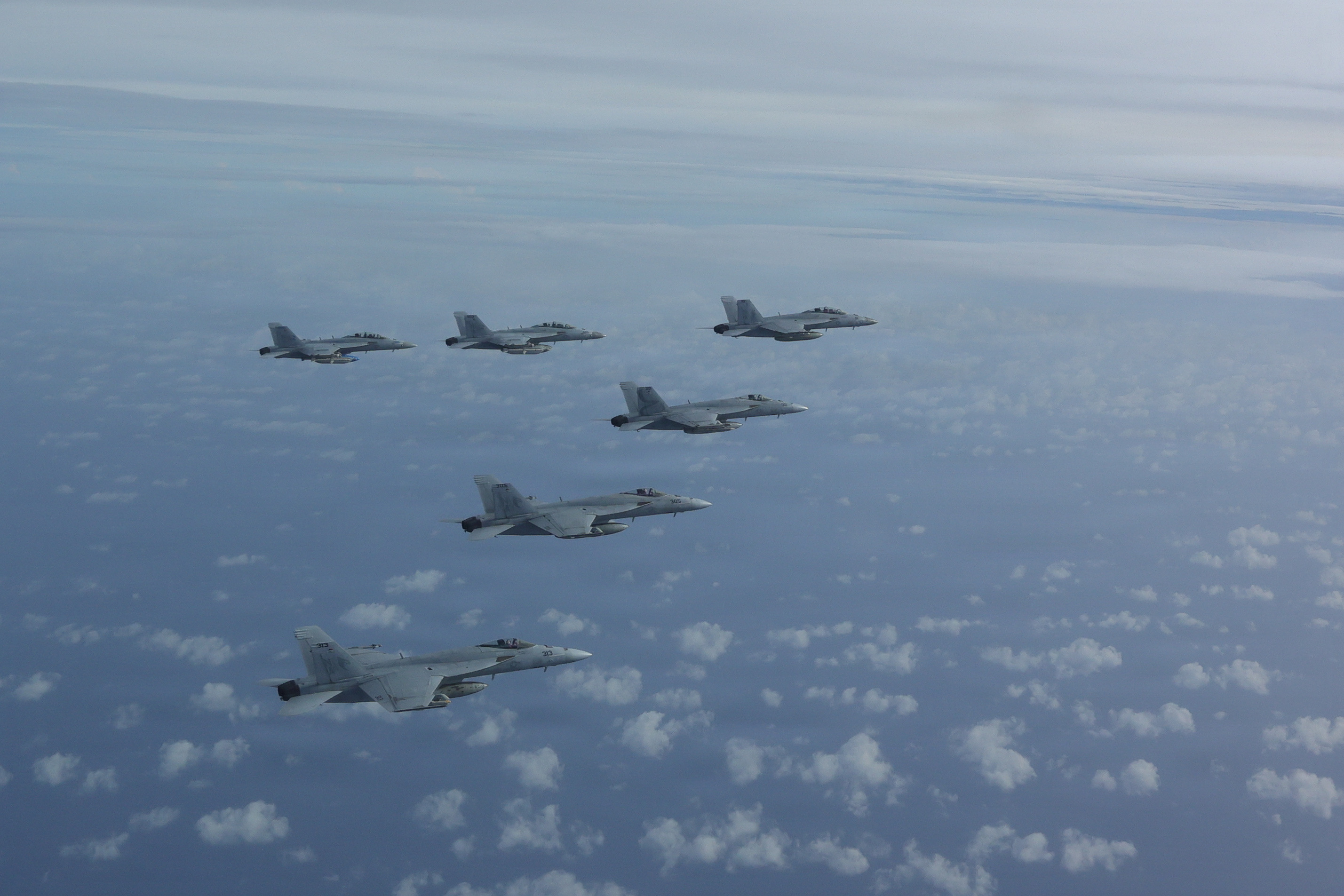 F/A-18E Super Hornets attached to the “Kestrels” of Strike Fighter Squadron (VFA) 137, fly in formation during an air power demonstration over the Gulf of America, June 11, 2026. U.S. military forces are deployed to the U.S. Southern Command area of responsibility in support of Department of War-directed operations, and the president's priorities to disrupt illicit drug trafficking, deter malign actors and protect the homeland through continuous presence. Nimitz-class aircraft carriers are the pinnacle of mobile naval air power projection and forward operational presence. No other weapons system possesses the responsiveness, endurance, multi-dimensional might, inherent battlespace awareness, and command and control capabilities of a carrier strike group and its embarked air wing. (U.S. Navy photo by LT Will 