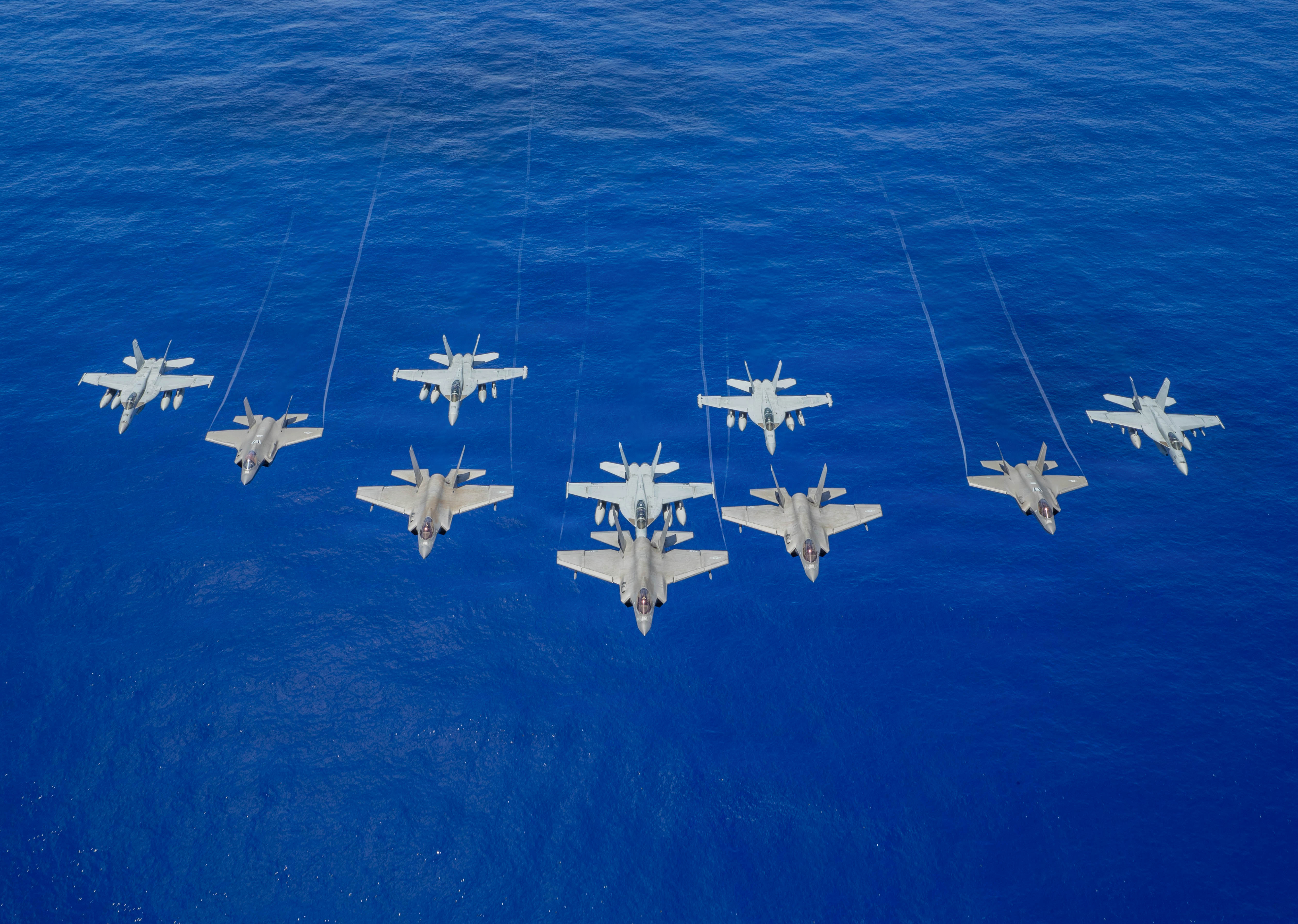 U.S. Navy aircraft, attached to Carrier Air Wing (CVW) 5, and U.S. Air Force F-35A Lightning IIs fly during joint operations with U.S. Navy George Washington Carrier Strike Group and Japan Maritime Self-Defense Force, as part of Valiant Shield 2026 while underway in the Philippine Sea, June 21, 2026. Valiant Shield is a biennial, multilateral field training exercise conducted by the U.S. Armed Forces and partner nations in the Western Pacific focusing on joint, cross-combatant integration operating seamlessly across sea, air, land, and cyberspace. Exercises like Valiant Shield allow U.S. Pacific Command the opportunity to integrate forces from all branches of service and with our allies to conduct precise, lethal, and overwhelming multi-domain effects that demonstrate the strength and versatility of the Joint Force and our commitment to a free and open Indo-Pacific. (U.S. Navy photo by Mass Communication Specialist 3rd Class Estrella Velarde)