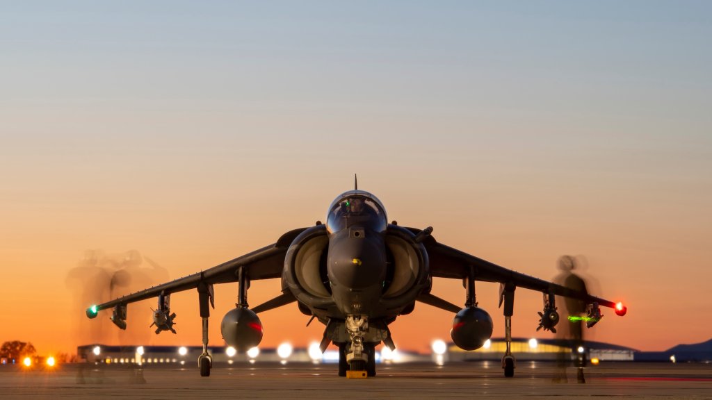 A Marine plane captain, from Marine Attack Squadron 223, Cherry Point, North Carolina, observes pre-flight checks of an AV-8B Harrier at Gowen Field, Boise, Idaho, April 19, 2021. The checks are designed to operational check various flight controls of the aircraft.