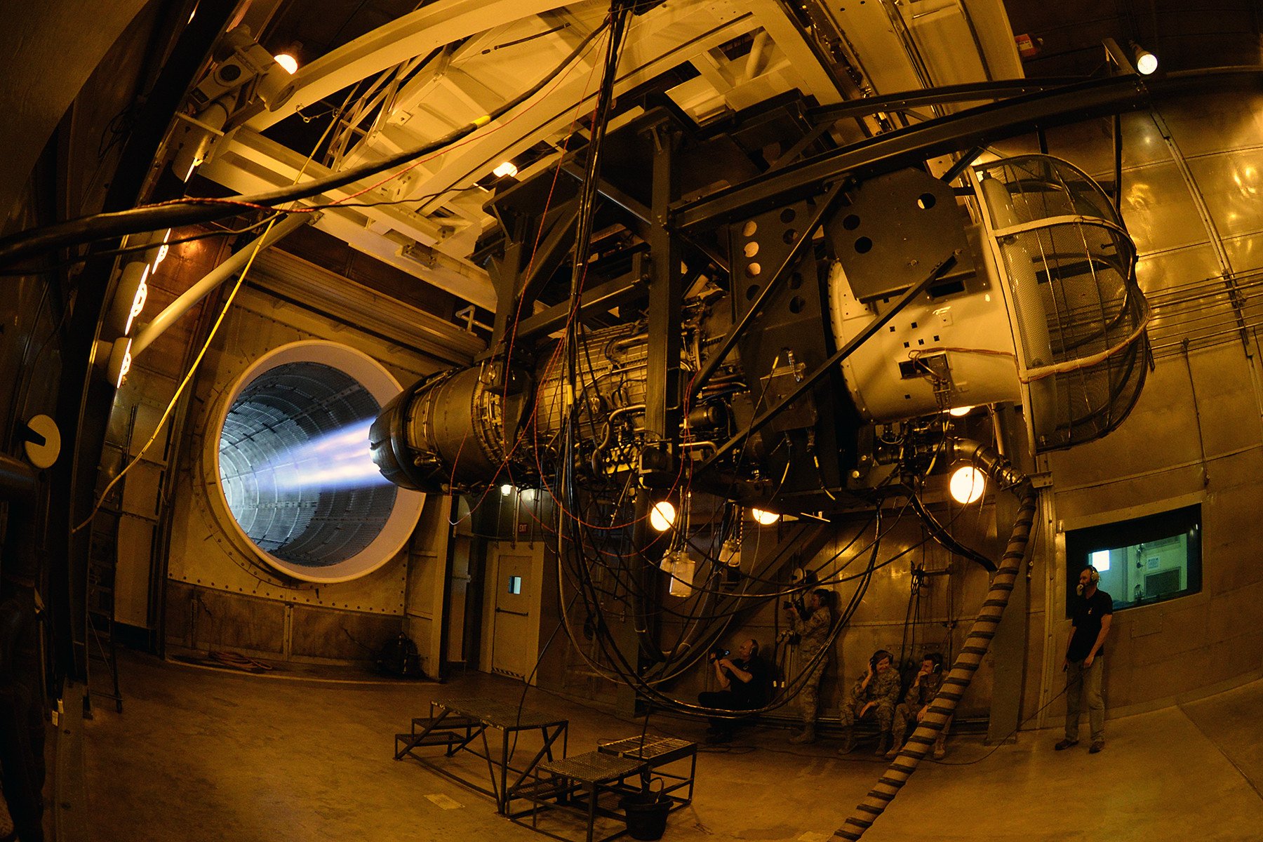 Airmen from 2nd Audiovisual Squadron film an F-16 jet Fighting Falcon engine in max power during a test in the 576th Aircraft Maintenance Squadron’s hush house engine facility at Hill Air Force Base, Utah, June 5, 2019. The shop is responsible for performing organizational level maintenance on more than 200 engines per year. The shop’s maintenance tasks include engine inspections, external engine component removal and replacement, repairs and troubleshooting during flightline and test cell operations. (U.S. Air Force photo by Alex R. Lloyd)