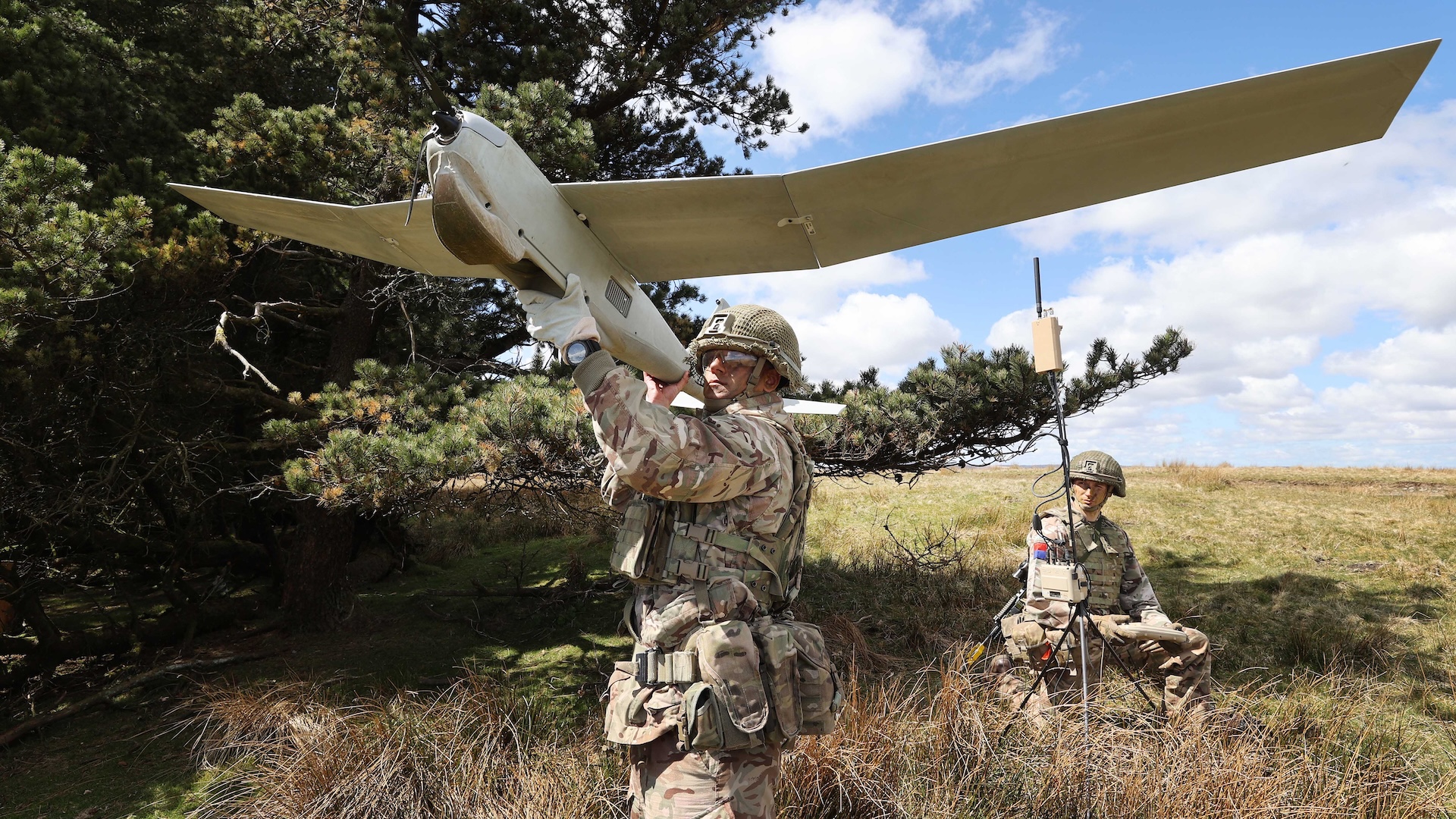 Pictured: PUMA AE 2 Drone, a Fixed Wing UAV is launched during a tactical training exercise by a 32 REGT Gunner, while another soldier fly’s the device with a laptop and controller. The Puma is just over 4½ft long, with a wingspan of 9ft, and is designed to fly for up to two hours carrying out reconnaissance and intelligence gathering missions over sea or land. The drone can monitor an area larger than the size of Greater Manchester during its flights, feeding back real-time footage to help soldiers make accurate tactical decisions. Personnel from the Royal Artillery, test a suite of cutting-edge equipment at Sennybridge training area, including a digital communications hub that allows observation posts, HQs and joint fires cell to receive and see the same information feeds simultaneously and talk directly to strike assets including heavy artillery, rockets, mortars and aircraft. Interactive on-screen graphics with integrated ISTAR functionality at all levels allows for agile offensive and defensive manoeuvres. The live data feed can include outputs from sonic and radar artillery monitors such as Mamba, LCMR and ASP as well as video, stills and infra-red images from drones.