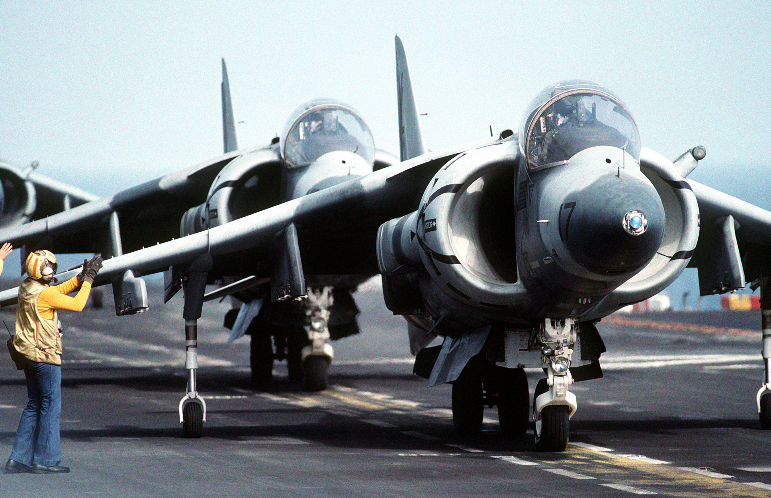 Two Marine Corps AV-8B Harrier aircraft are given final preflight checks as their pilots prepare for takeoff from the amphibious assault ship USS NASSAU (LHA-4) during Operation DESERT SHIELD. (USN PHOTO BY PH1(AC) SCOTT M. ALLEN DN-ST-91-11239)