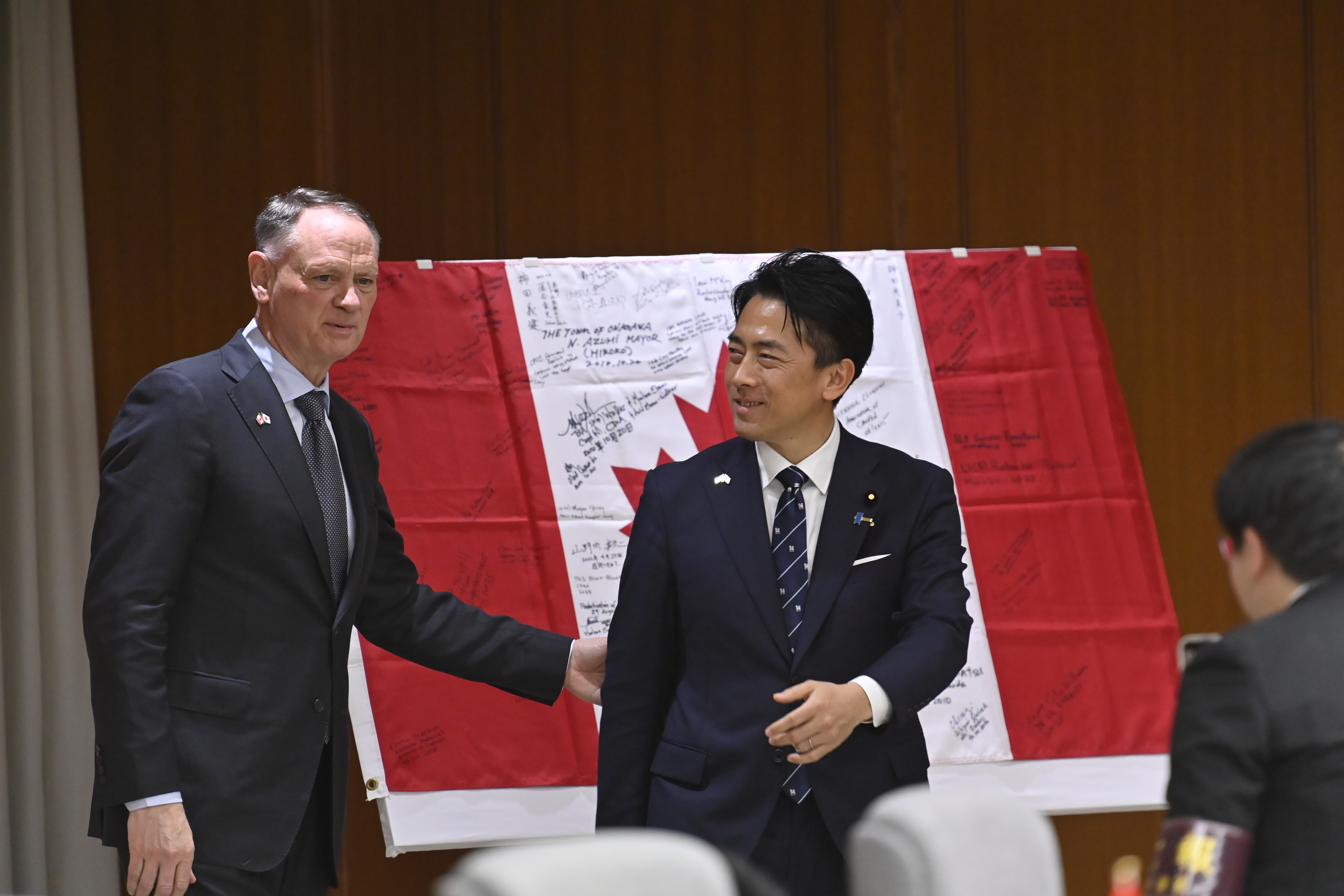 TOKYO, JAPAN - FEBRUARY 6: Japanese Defense Minister Shinjiro Koizumi and Canadian Defense Minister David McGuinty pose after signing the friendship memorial flag in turn before their meeting in Tokyo, Japan, on February 6, 2026. The flag stands as a symbol of remembrance, peace and reconciliation between Japan and Canada. (Photo by David Mareuil/Anadolu via Getty Images)