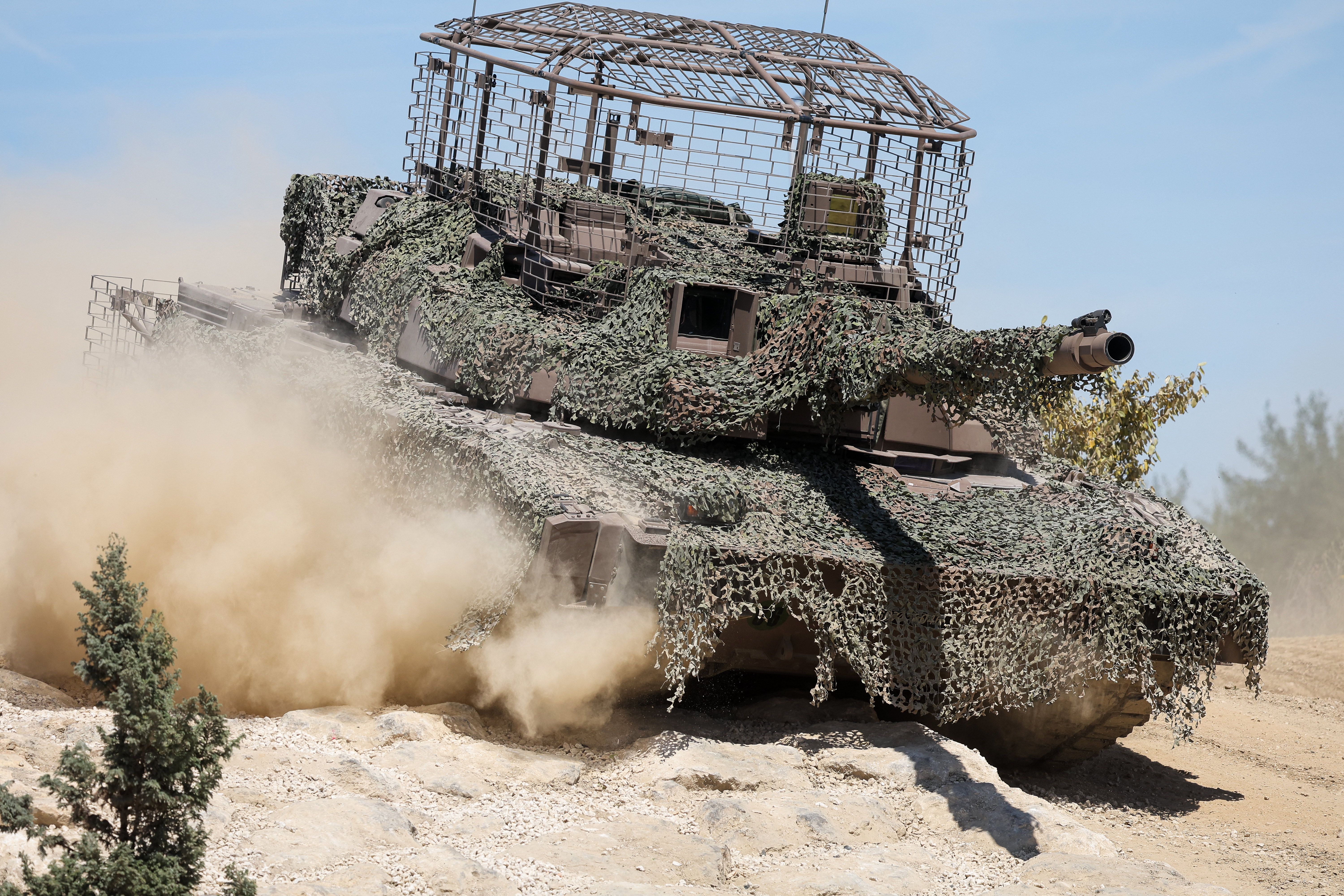 This photograph shows a AMX Leclerc (Char Leclerc) battle tank with an anti-drone cage in its top during a dynamic demonstration of military equipment at the Eurosatory trade show, dedicated to defense and security, at the Paris Nord Villepinte Exhibition Center in Villepinte, northeastern suburb of Paris on June 14, 2026. The Eurosatory trade show takes place from June 15 to 19, 2026. (Photo by Kenzo TRIBOUILLARD / AFP via Getty Images)