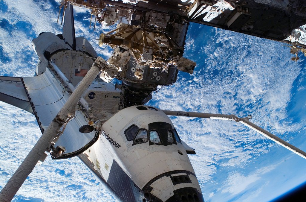  In this handout photo provided by NASA, backdropped by the blackness of space and Earth's horizon, the Space Shuttle Endeavour, docked to the Pressurized Mating Adapter (PMA-2) on the International Space Station, is featured in this photograph taken by a crewmember during the mission's first planned session of extravehicular activity (EVA) August 15, 2007 in Space. (Photo by NASA via Getty Images)