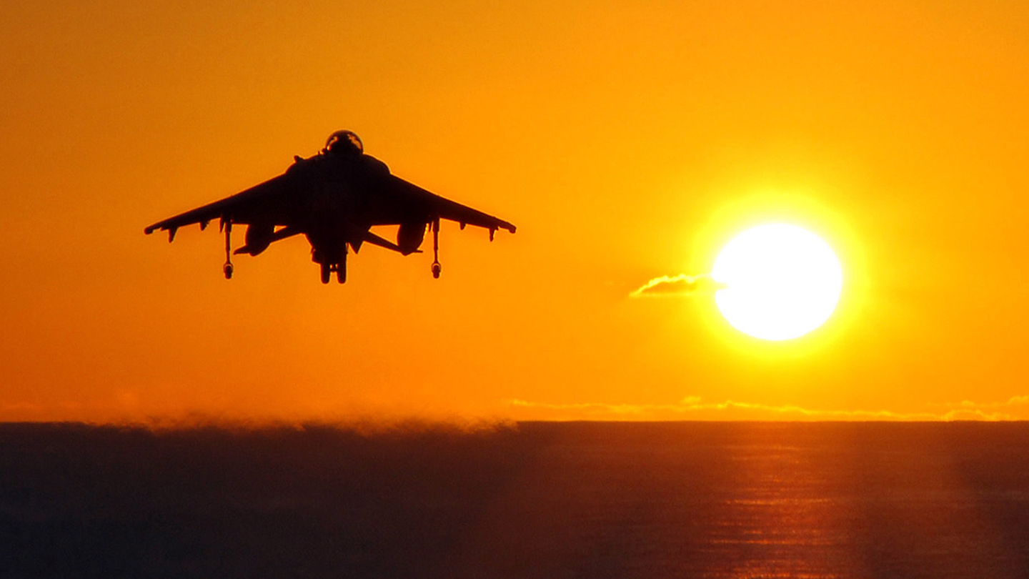 A Marine AV-8B Harrier takes off from amphibious assault ship USS Tarawa (LHA 1) just before sunset. Tarawa, along with embarked 11th Marine Expeditionary Unit, is on a scheduled deployment to the Western Pacific in support of maritime security operations and the Global War on Terrorism.