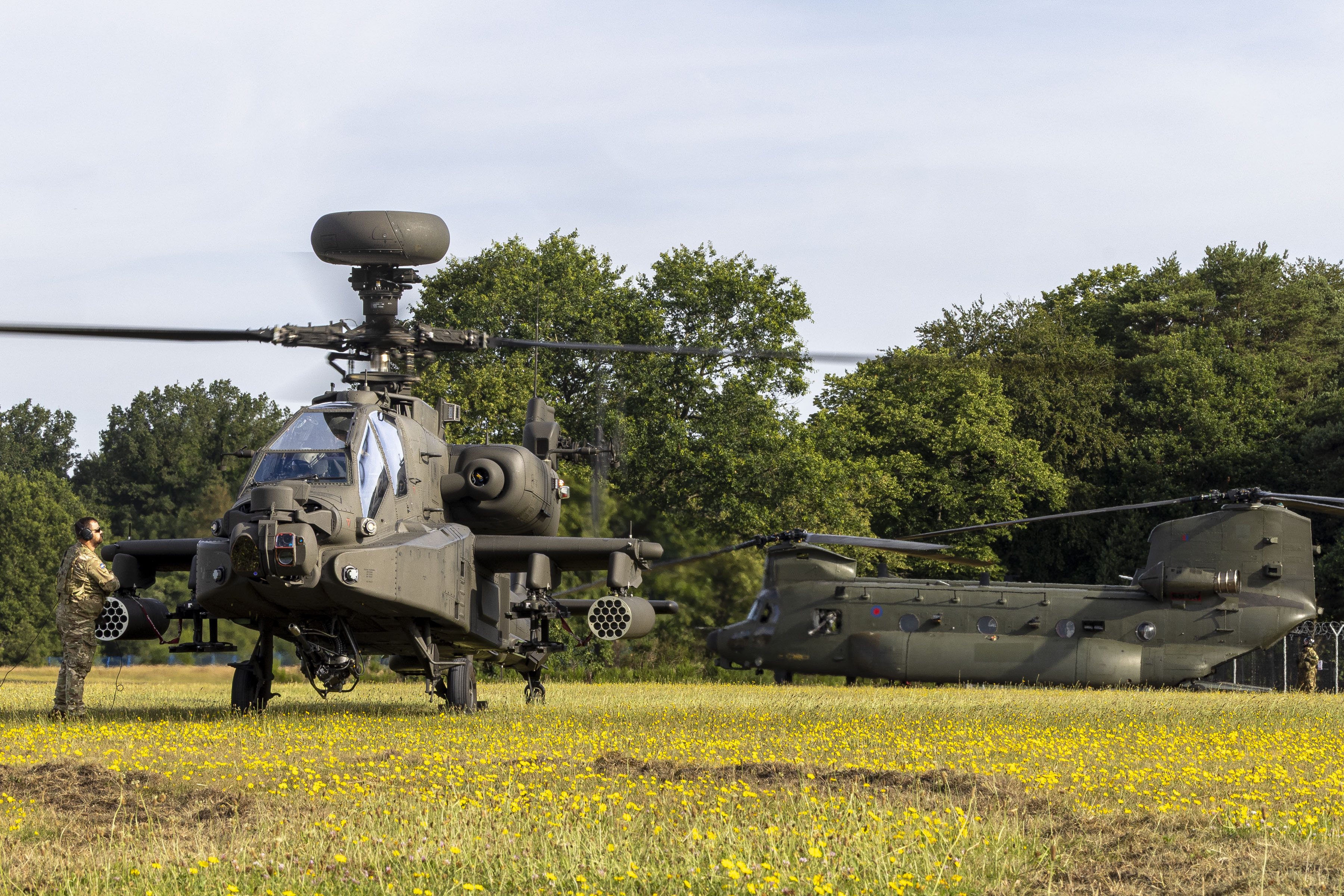 Pictured: A British Army Apache and RAF Chinook land at the Armed Forces Day national event in Aldershot on Saturday 27th June 2026. This prestigious national event brings the communities of Aldershot and Farnborough together with the military community in celebration and appreciation, through fantastic free activities, sports and entertainment. It is a chance for all to thank the Armed Forces for the vital role they play in protecting the nation. Service personnel from the Royal Navy, Royal Marines, Army, and Royal Air Force showcase the diverse mix of roles in the Armed Forces, demonstrating equipment, and highlighting their contribution to national security. Visitors are able to meet serving personnel, reservists, veterans, cadets, and military families during the weekend, which includes live military bands, parades and flypasts. The programme of activities also looks to the future by inspiring young people through displays, activities, sports, and family events.