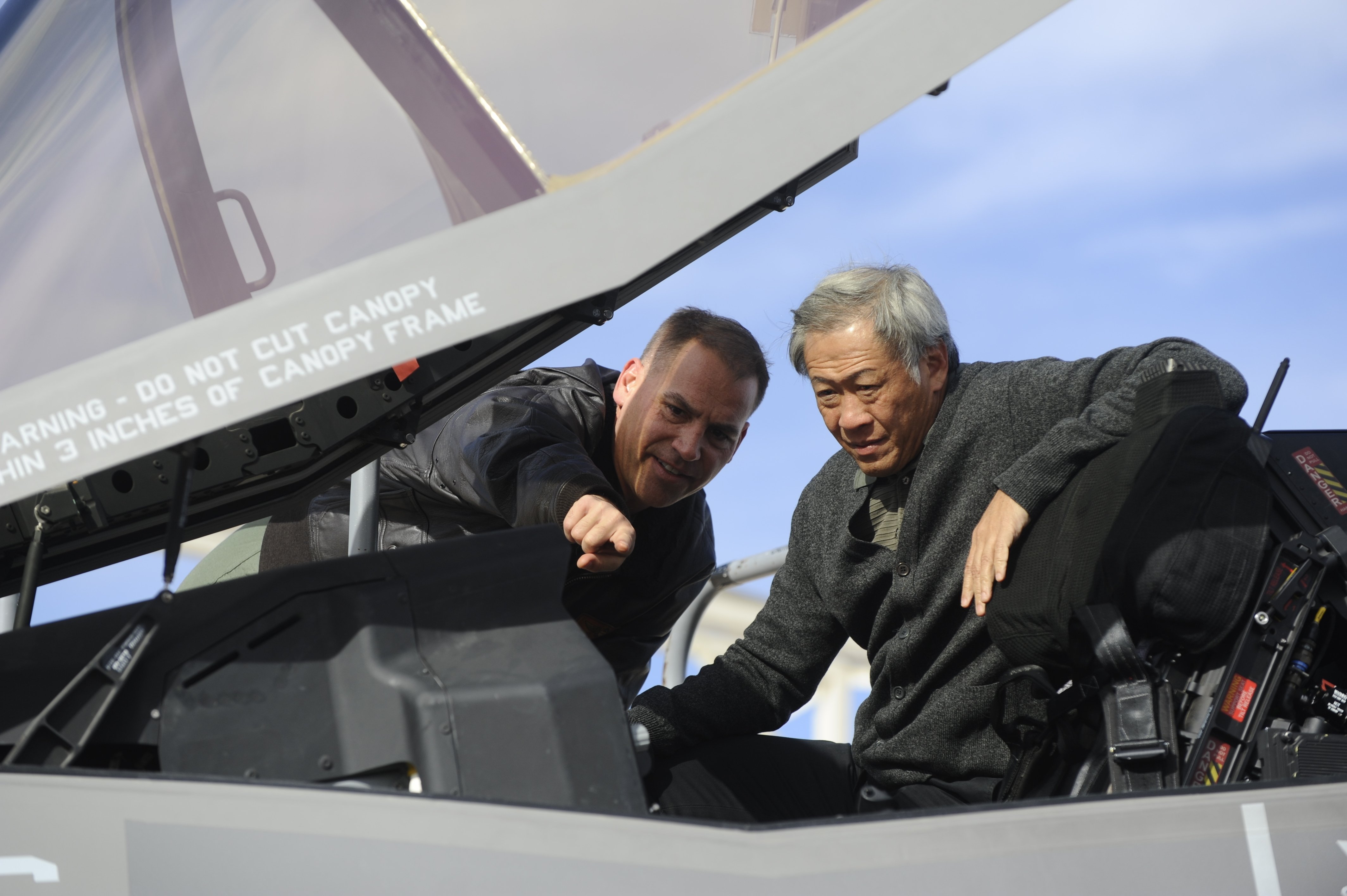 U.S. Marine Corps Lt. Col. Steve Gillette, VMFA-121 squadron commander, explains the capabilities of the F-35B Lightning II to Dr. Ng Eng Hen, Singapore minister of defense, at Luke Air Force Base, Ariz., Dec. 10, 2013. (U.S. Air Force photo by Senior Airman Jason Colbert)