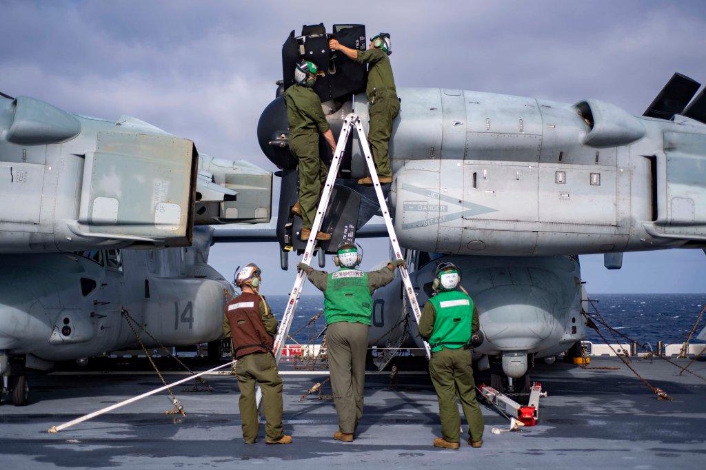 200127-N-RU810-1026 PHILIPPINE SEA (Jan. 27, 2020) Marines assigned to the “Dragons” of Marine Medium Tiltrotor Squadron (VMM) 265 (Reinforced), 31st Marine Expeditionary Unit (MEU) perform maintenance on a rotor blade of a MV-22 Osprey on the flight deck of amphibious assault ship USS America (LHA 6). America, flagship of the America Expeditionary Strike Group, 31st Marine Expeditionary Unit team, is operating in the U.S. 7th Fleet Area of operations to enhance interoperability with allies and partners and serve as a ready response force to defend peace and stability in the Indo-Pacific region. (U.S. Navy photo by Mass Communication Specialist 3rd Class Vincent E. Zline)