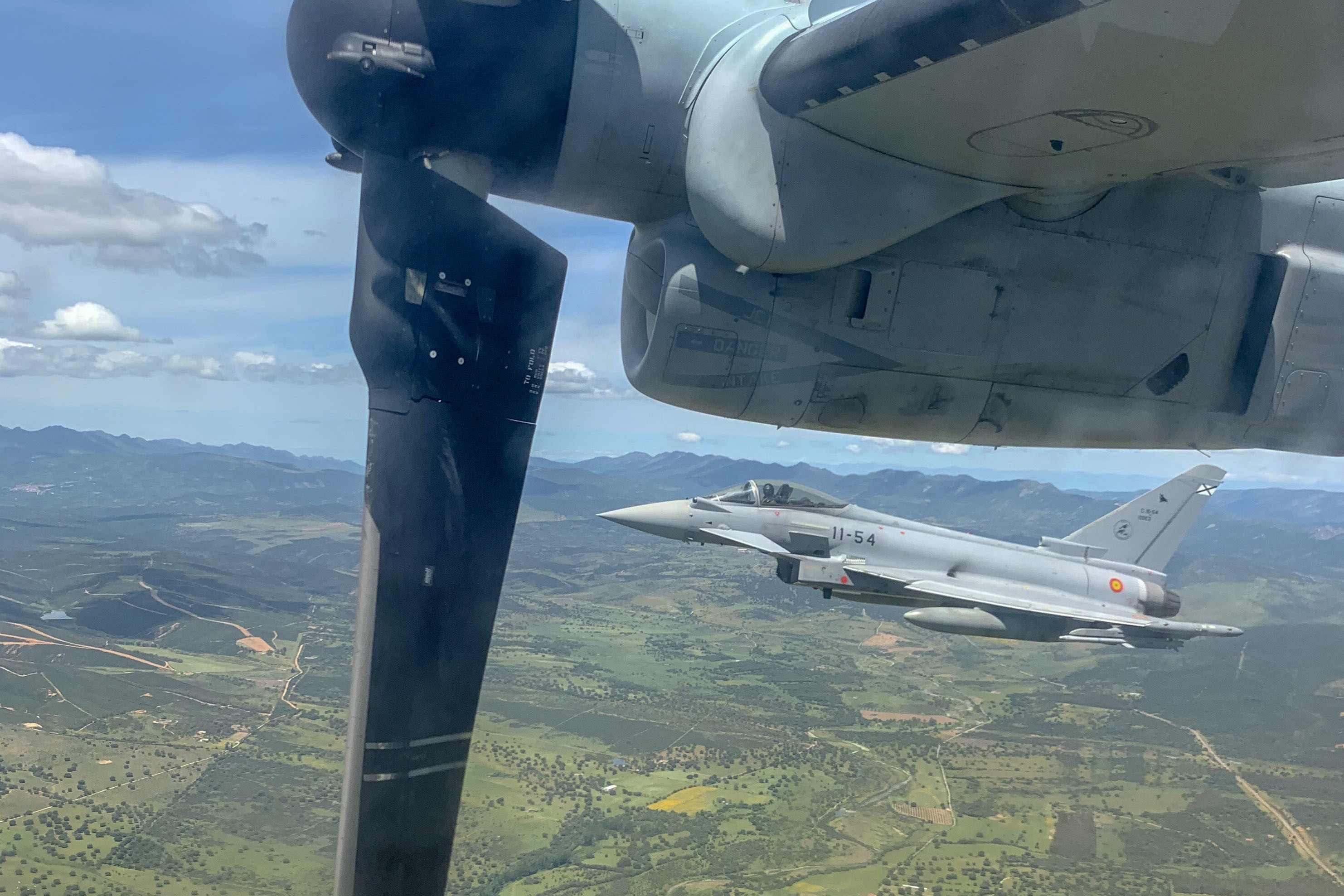 A Spanish Air Force Eurofighter Typhoon with the 11th Wing flies next to a U.S. Marine Corps MV-22 Osprey with Special Purpose Marine Air-Ground Task Force-Crisis Response-Africa 20.1, Marine Forces Europe and Africa, as part of a tactical recovery of air-craft and personnel (TRAP) exercise near Morón Air Base, Spain, May 6, 2020. The aviation combat element rehearses TRAP to maintain proficiency and increase the operational reach of supported aircraft. SPMAGTF-CR-AF is deployed to conduct crisis-response and theater-security operations in Africa and promote regional stability by conducting military-to-military training exercises throughout Europe and Africa. (U.S. Marine Corps photo by Cpl. Kenny Gomez)