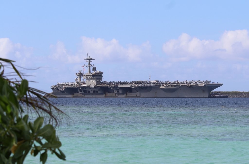 APRA HARBOR, Guam (Dec. 11, 2025) - Nimitz-class aircraft carrier USS Abraham Lincoln (CVN 72) pulls into Naval Base Guam for a scheduled port visit, Dec. 11. Abraham Lincoln Strike Group is on a scheduled deployment in the U.S. 7th Fleet area of operations to enhance interoperability through alliances and partnerships while serving as a ready-response force in support of a free and open Indo-Pacific region. (U.S. Navy photo by Valerie Maigue)