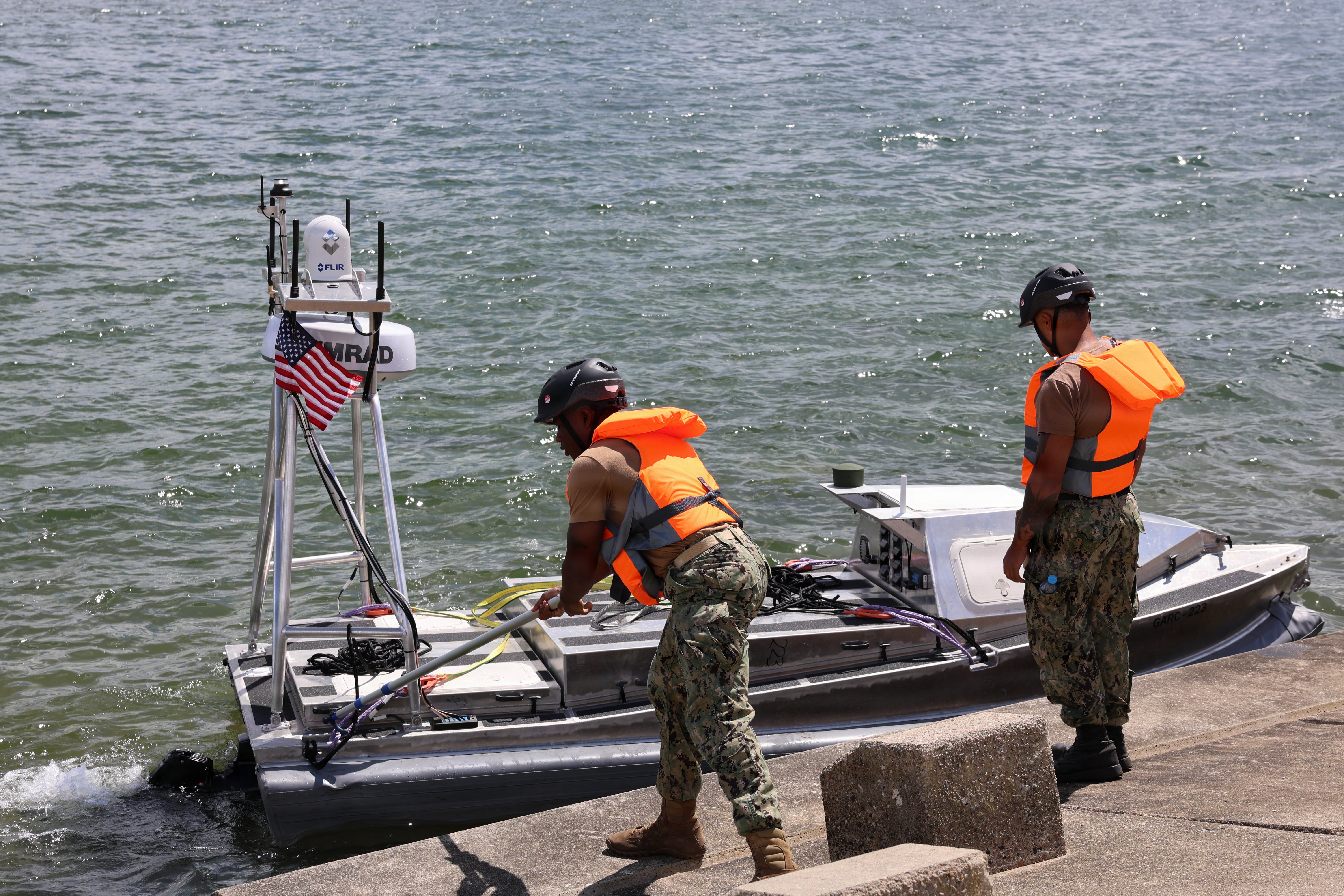 260612-N-LY640 GDYNIA, Poland (June 12, 2026) – Sailors assigned to Unmanned Surface Vessel Squadron (USVRON) 3 Division 32, push a global autonomous reconnaissance craft (GARC) off the wall during a pier-side launch into the Port of Gdynia during exercise Baltic Operations (BALTOPS) 2026, June 12, 2026. BALTOPS 2026, the premiere maritime-focused exercise in the Baltic Sea region, provides a unique training opportunity to strengthen combined response capabilities critical to preserving freedom of navigation and security in the Baltic Sea. (U.S. Navy photo by Chief Mass Communication Specialist Sandi Grimnes Moreno)