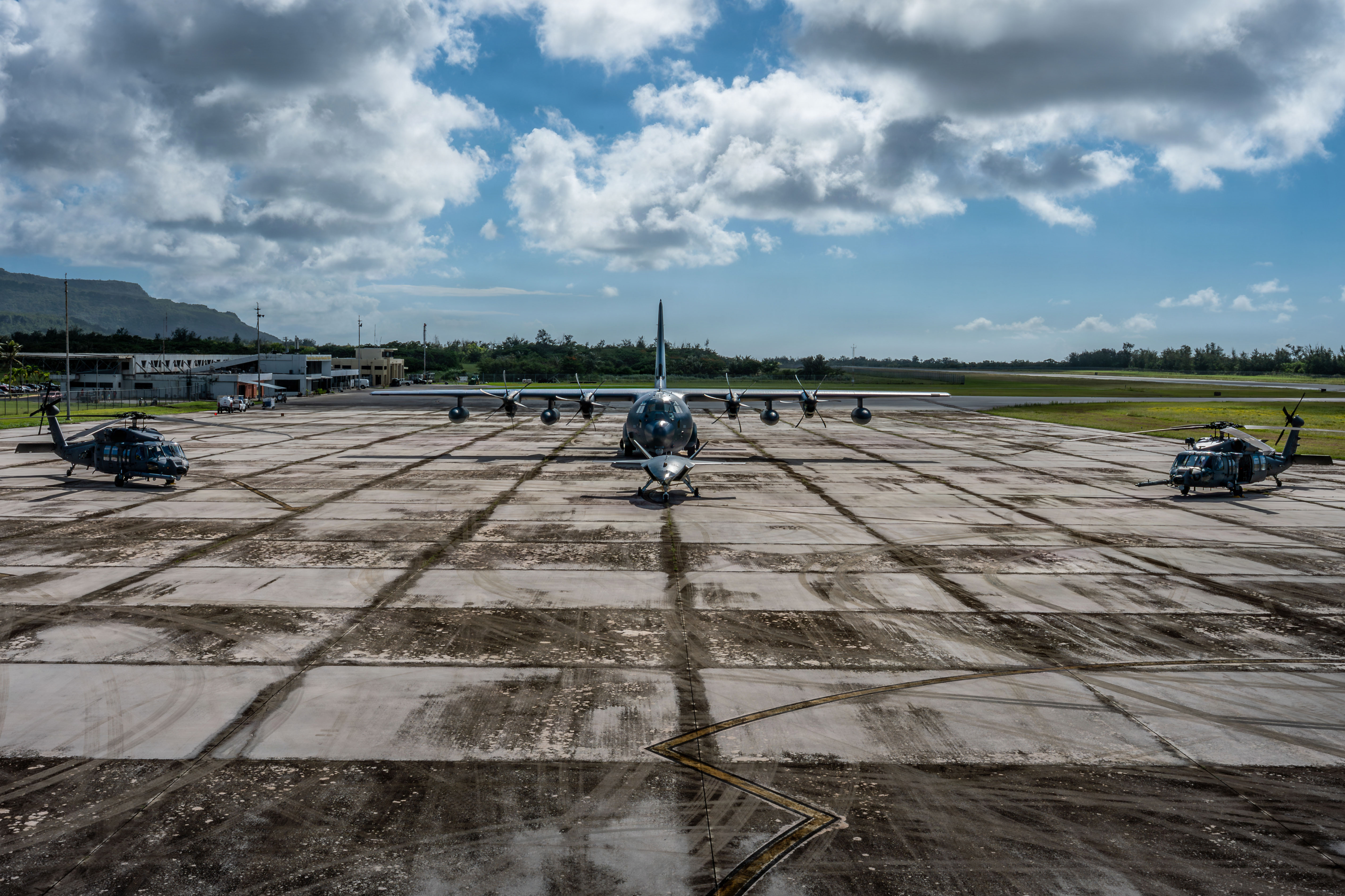 A U.S. Air Force HH-60W Jolly Green IIs assigned to the 55th Rescue Squadron; an HC-130J Combat King II assigned to the 79th Rescue Squadron, and Boeing Defence Australia's MQ-28 Ghost Bat are shown together in Rota, Commonwealth of the Northern Mariana Islands, June 28, 2026, in support of VALIANT SHIELD 2026. Exercises like VALIANT SHIELD allow Pacific Command Joint Forces the opportunity to integrate forces from all branches of service and with our allies to conduct precise, lethal, and overwhelming multi-axis, multi-domain effects that demonstrate the strength and versatility of the joint force and our commitment to a free and open Indo-Pacific. (U.S. Air Force photo by Tech. Sgt. Tristan Truesdell)