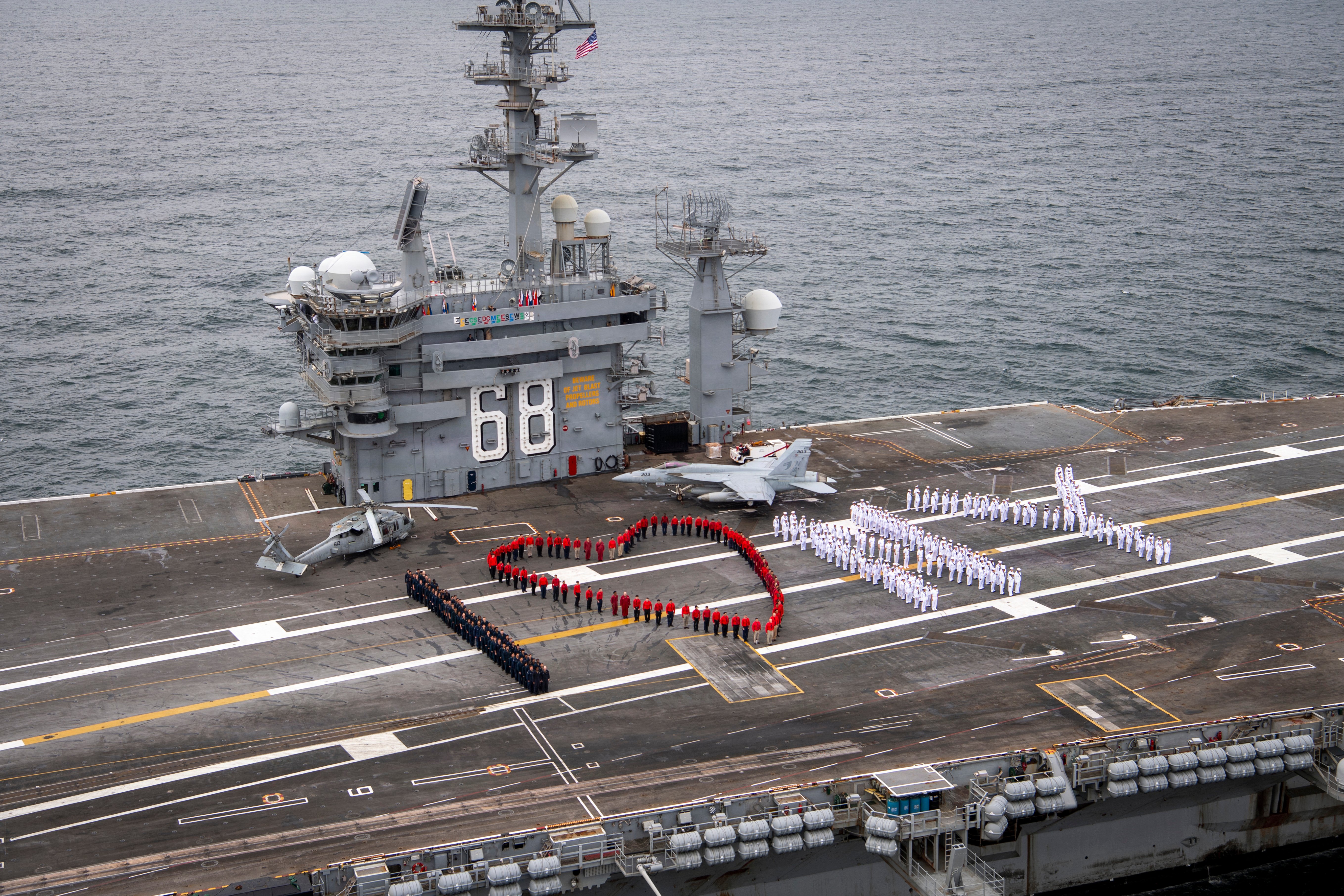 Sailors spell out “I [Heart] NY” on the flight deck of Nimitz-class aircraft carrier USS Nimitz (CVN 68) after the ship departed New York Harbor following its participation in International Naval Review 250, July 7, 2026. Nimitz is underway in the U.S. 2nd Fleet area of responsibility as part of a scheduled homeport shift to Norfolk, Virginia. (U.S. Navy photo by Mass Communication Specialist Seaman Alyssa Boling)