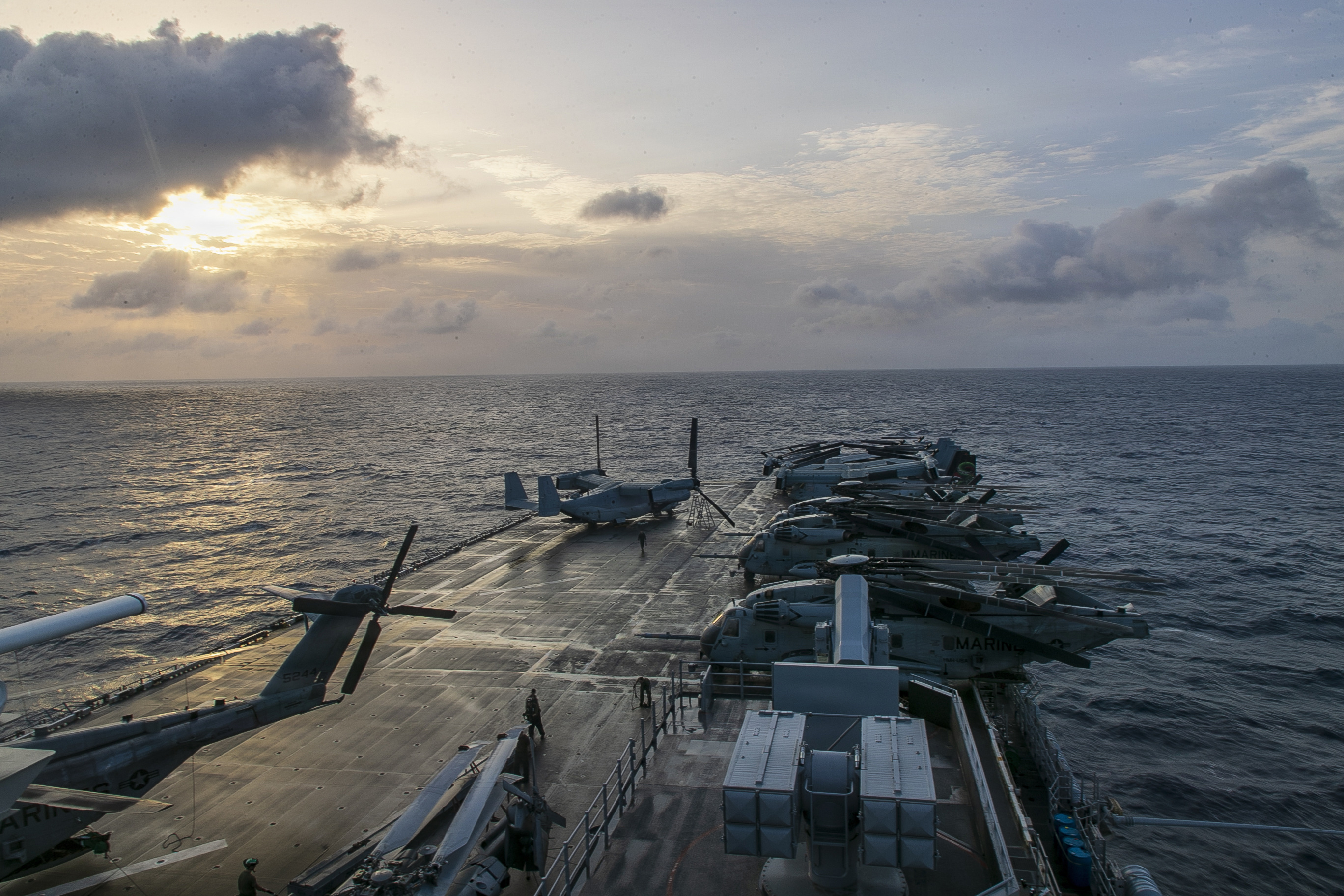 The sun rises over the flight deck of forward-deployed America-class amphibious assault ship USS Tripoli (LHA 7), July 8, 2026. Tripoli is currently underway conducting routine operations in the U.S. 7th Fleet area of operations. U.S. 7th Fleet, the U.S. Navy’s largest forward-deployed numbered fleet, routinely interacts and operates with allies and partners in preserving a free and open Indo-Pacific. (U.S. Navy photo by Chief Mass Communication Specialist Leonard Adams)