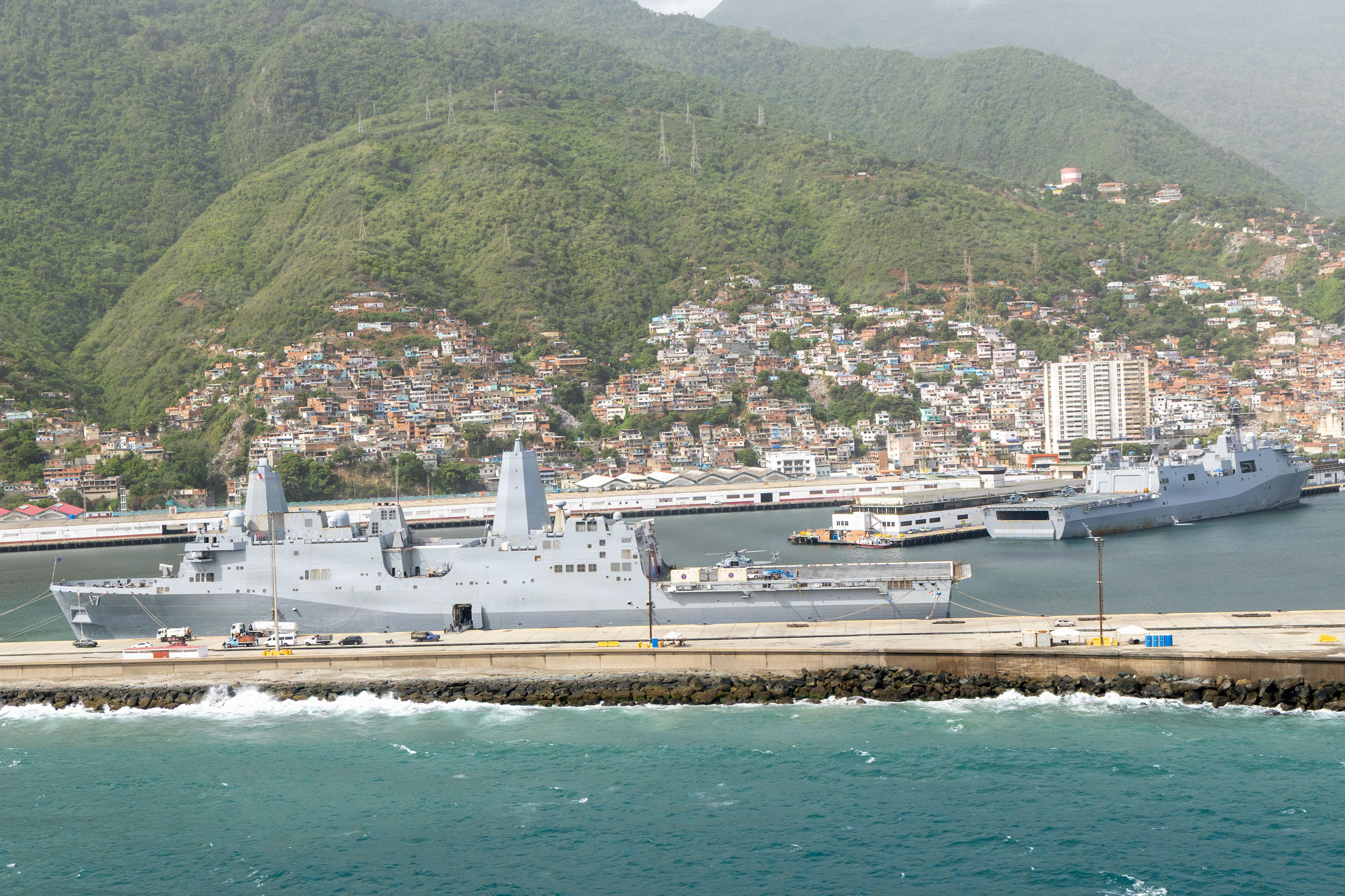 The San Antonio-class amphibious transport dock USS San Antonio (LPD 17), left, and the USS San Antonio-class amphibious transport dock USS Fort Lauderdale (LPD 28), right, both ported during a cross-decking movement in La Guaira, Venezuela, July 9-10, 2026. At the direction of U.S. Southern Command, assigned U.S. military forces are supporting Department of State-led U.S. disaster assistance to the people of Venezuela in the aftermath of the June 24, 2026, earthquakes. (U.S. Marine Corps photo)