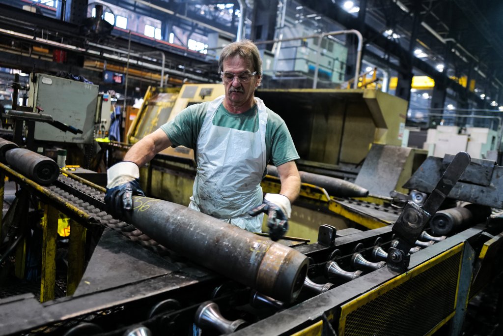 TOPSHOT - An employee handles 155 mm caliber shells after the manufacturing process at the Scranton Army Ammunition Plant (SCAAP) in Scranton, Pennsylvania on April 16, 2024. In brick buildings that are more than a century old, nearly in the heart of Joe Biden's Rust Belt hometown of Scranton, Pennsylvania, dated machinery churns artillery for modern conflicts, especially the war in Ukraine. The Scranton Army Ammunition Plant (SCAAP) is making steel tubes for 155 mm caliber shells, which are crucial to Kyiv's efforts to face down Moscow's invasion. (Photo by Charly TRIBALLEAU / AFP) (Photo by CHARLY TRIBALLEAU/AFP via Getty Images)