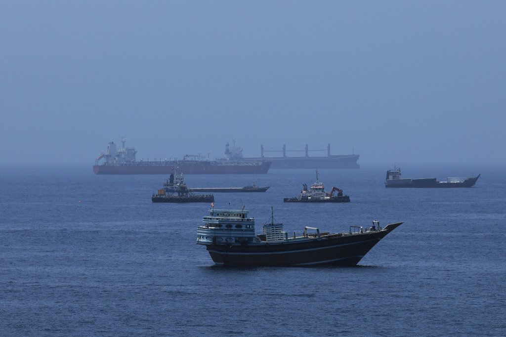 MUSCAT, OMAN - JUNE 21: A view of commercial cargo vessels and crude oil tankers are anchored in the Gulf of Oman, off the coast of Muscat, Oman, on June 21, 2026, as they prepare to transit through the critical Strait of Hormuz. Maritime traffic along this vital global trade corridor experienced severe disruptions following heightened geopolitical tensions between the United States and Iran that escalated earlier in February. Following a diplomatic memorandum of understanding reached in mid-June, the strategic waterway is expected to fully reopen to international shipping and energy transit. (Photo by Shady Alassar/Anadolu via Getty Images)