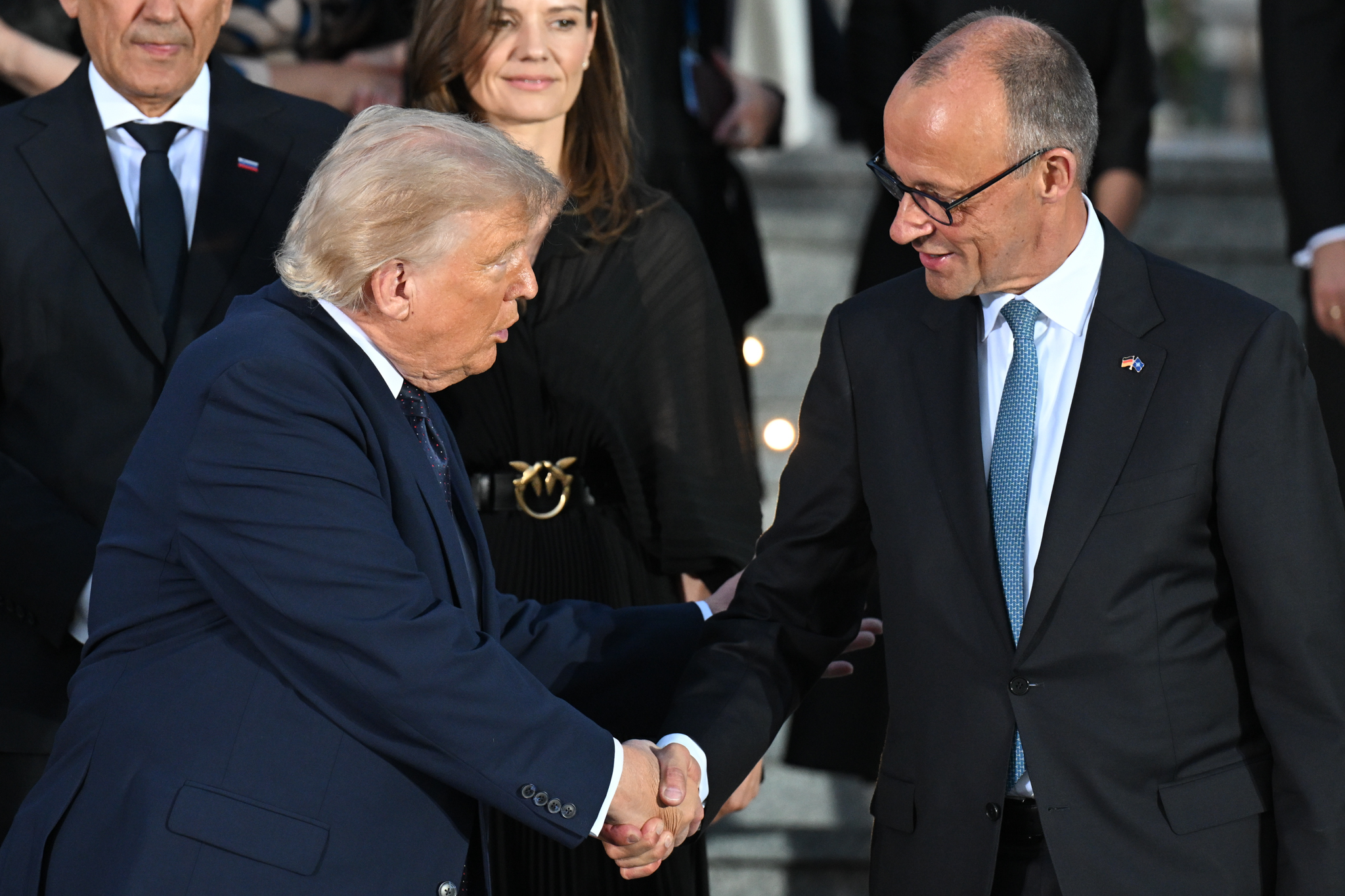 ANKARA, TURKIYE - JULY 7: US President Donald Trump and German Chancellor Friedrich Merz shake hands before the family photo with the summit participants during a reception at the Presidential Complex in honor of heads of state and government, along with their spouses, attending the 36th NATO Summit in Ankara, Turkiye on July 7, 2026. (Photo by Mehmet Ali Ozcan/Anadolu via Getty Images)