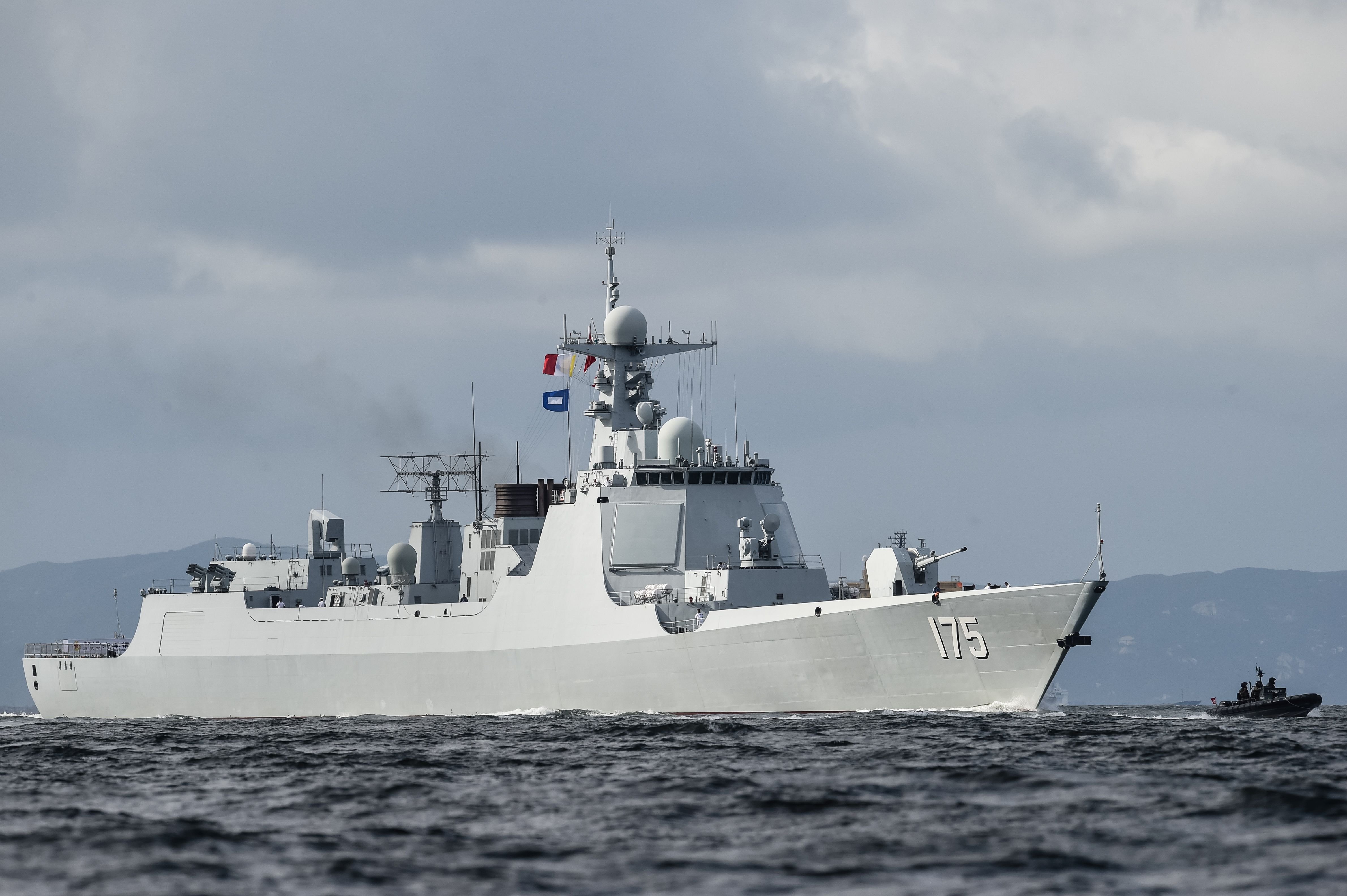The Yinchuan (175), a Type 052D destroyer of China's People's Liberation Army Navy (PLAN), provides an escort ahead of the Liaoning aircraft carrier into the Lamma Channel as it arrives in Hong Kong territorial waters on July 7, 2017. China's sole operational aircraft carrier arrived in Hong Kong for the first time in a display of military might less than a week after a high-profile visit by president Xi Jinping. / AFP PHOTO / ANTHONY WALLACE (Photo credit should read ANTHONY WALLACE/AFP via Getty Images)