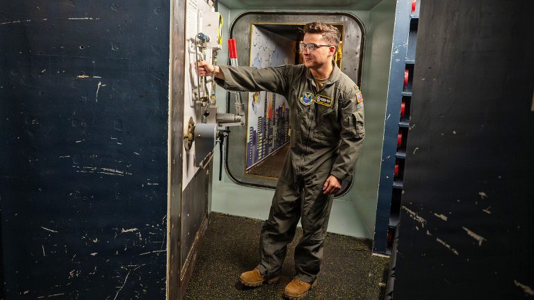 U.S. Air Force 2nd Lt. Garret Burgess, 490th Missile Squadron nuclear and missile operations officer, pulls a blast door inside a launch control center at Malmstrom Air Force Base, Montana, April 11, 2026. The blast door secures access to the underground Launch Control Center, where missileers maintain continuous command and control of assigned intercontinental ballistic missile forces. (U.S. Air Force photo by Airman 1st Class Teniya Caldwell)