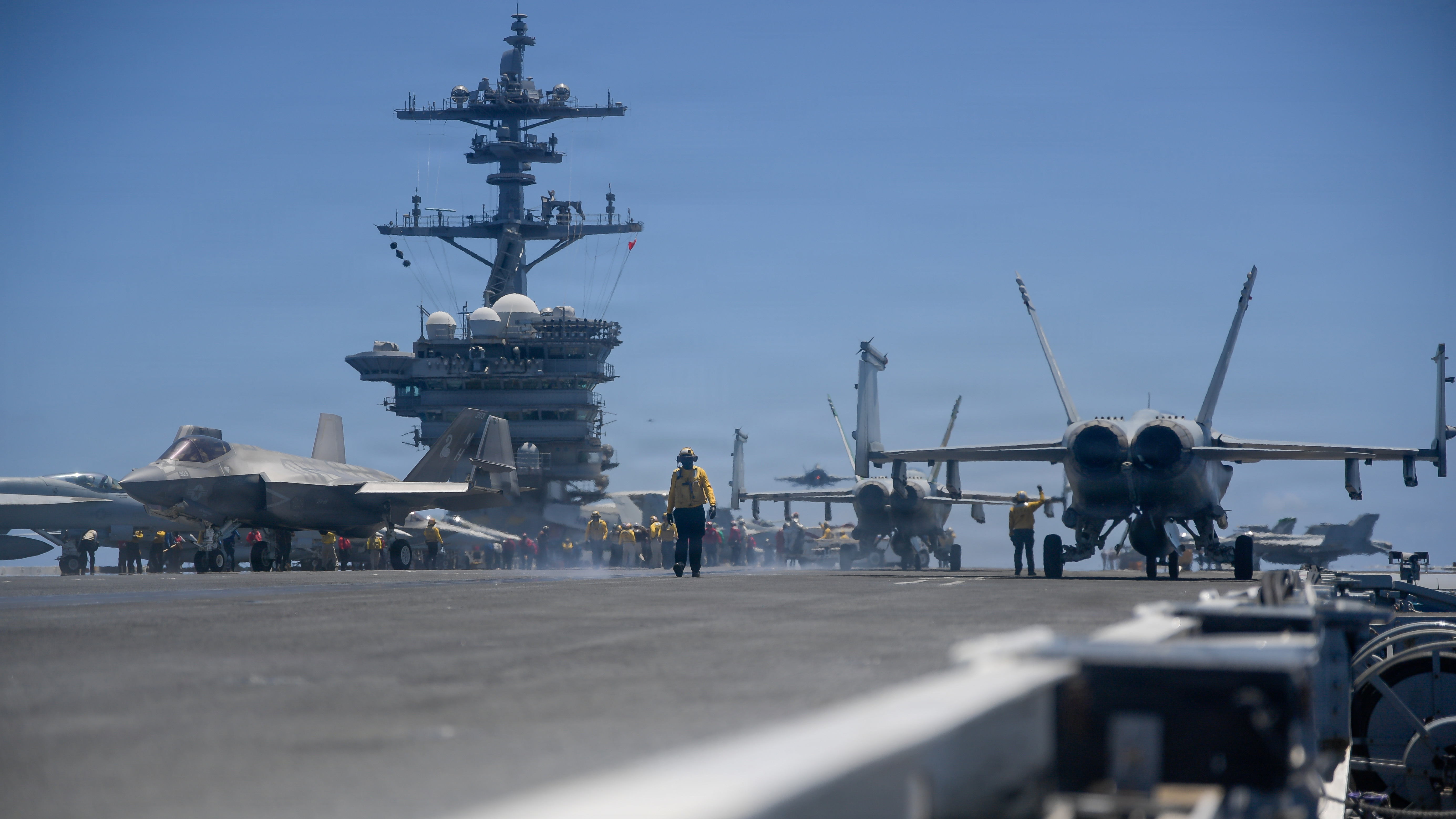 U.S. Navy Aviation Boatswain’s Mate (Handling) 3rd Class Roberto Rodriguez walks the flight deck of the Nimitz-class aircraft carrier USS Theodore Roosevelt (CVN 71) during Exercise Rim of the Pacific (RIMPAC), July 10, 2026. Thirty nations, over 30 ships, five submarines, 15 national land forces, more than 190 aircraft and more than 30,000 personnel are participating in RIMPAC in and around the Hawaiian Islands, June 24 to July 31. The world’s largest international maritime exercise, RIMPAC provides a unique training opportunity while fostering and sustaining cooperative relationships among participants critical to ensuring safety of sea lanes and security on the world’s oceans. RIMPAC 2026 is the 30th exercise in the series that began in 1971. (U.S. Navy photo by Mass Communication Specialist Seaman Tyler Harstad)