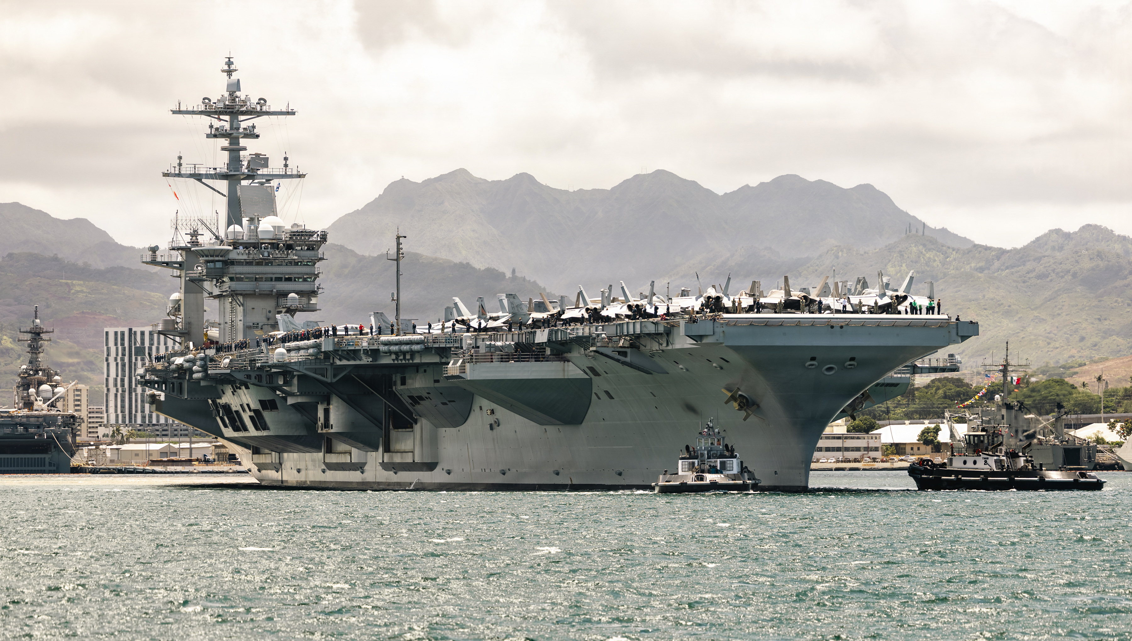 U.S. Navy Nimitz-class aircraft carrier USS Theodore Roosevelt (CVN 71) leaves Pearl Harbor, Hawaii, ahead of the sea phase of Exercise Rim of the Pacific 2026, July 7, 2026. Thirty nations, over 30 surface ships, five submarines, 15 national land forces, more than 206 aircraft and 30,000 personnel are participating in RIMPAC in and around the Hawaiian Islands, June 24 to July 31. The world's largest international maritime exercise, RIMPAC provides a unique training opportunity while fostering and sustaining cooperative relationships among participants critical to ensuring the safety of sea lanes and security on the world's oceans. RIMPAC 2026 is the 30th exercise in the series that began in 1971. (Royal Air Force Photo by Cpl. Tomas Barnard)