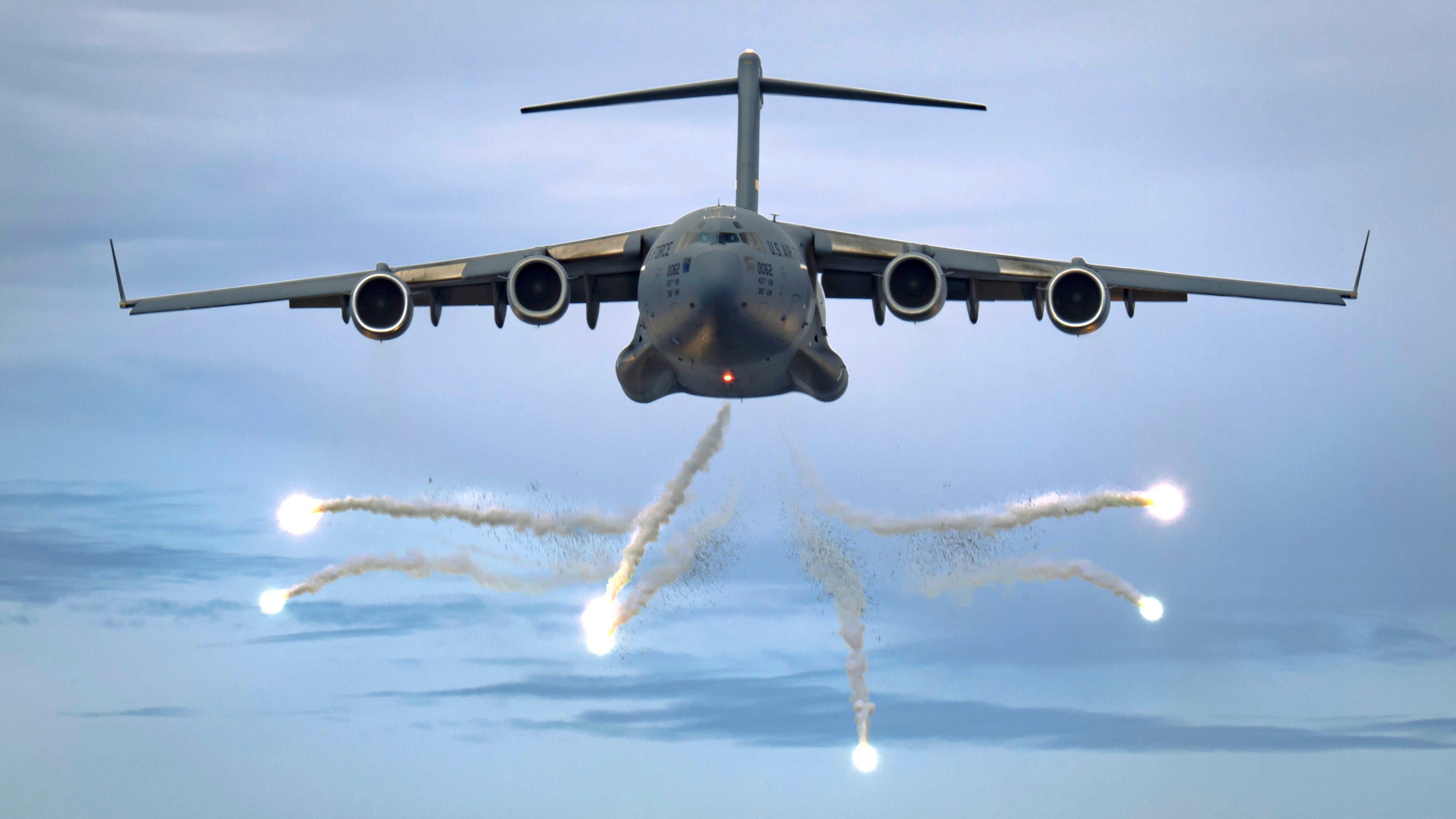 A U.S. Air Force C-17 Globemaster III from Joint Base Charleston deploys flares as part of a training event over the Atlantic ocean in a military operating area (MOA) outside Charleston, South Carolina, June 5, 2021. The C-17 is capable of rapidly and strategically delivering troops and all types of cargo to MOAs or forward-operating bases in deployment areas. The C-17 aircraft can perform tactical airlift and airdrop missions as well as transport litters and ambulatory patients during aeromedical evacuations. (U.S. Air Force photo by Tech. Sgt. Chris Hibben)
