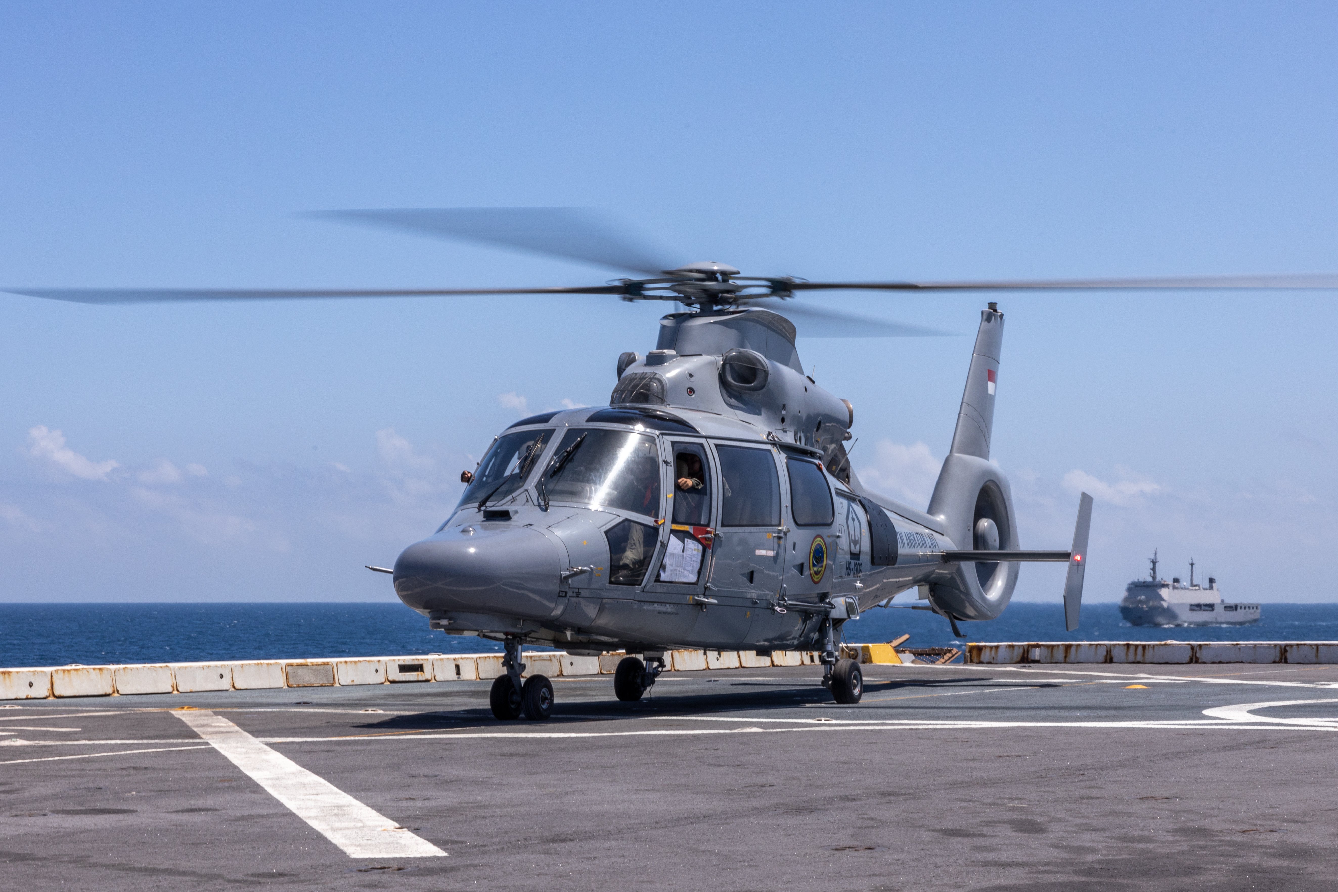 An Indonesia National Armed Forces AS565 Panther helicopter lands on the flight deck of the amphibious transport dock ship USS Green Bay (LPD 20), during a cross-deck exercise in the Java Sea, Sept. 4, 2024. The exercise showed the capabilities of multilateral communication and cooperation, enhancing interoperability between U.S., Singaporean and Indonesian fighting forces. Super Garuda Shield is an annual exercise that has significantly grown in scope and size since 2009. Super Garuda Shield 2024 is the third consecutive time this exercise has grown into a combined and joint event, focused on commitment to partnership and a Free and Open Indo-Pacific. (U.S. Marine Corps photo by Lance Cpl. Peter J. Eilen)