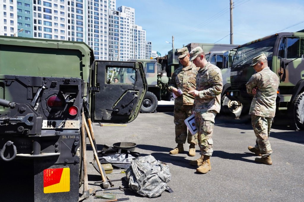U.S. Army inspector general assigned to the 19th Expeditionary Sustainment Command reviews a High Mobility Multipurpose Wheeled Vehicle (HMMWV) with Soldiers during a pre-convoy operations inspection at the Camp Henry motor pool, Republic of Korea, on July 31, 2026. The inspection ensured vehicles met operational and safety requirements before supporting convoy operations during Ulchi Freedom Shield 2026. (U.S. Army photo by Cpl. Ji Won Park)