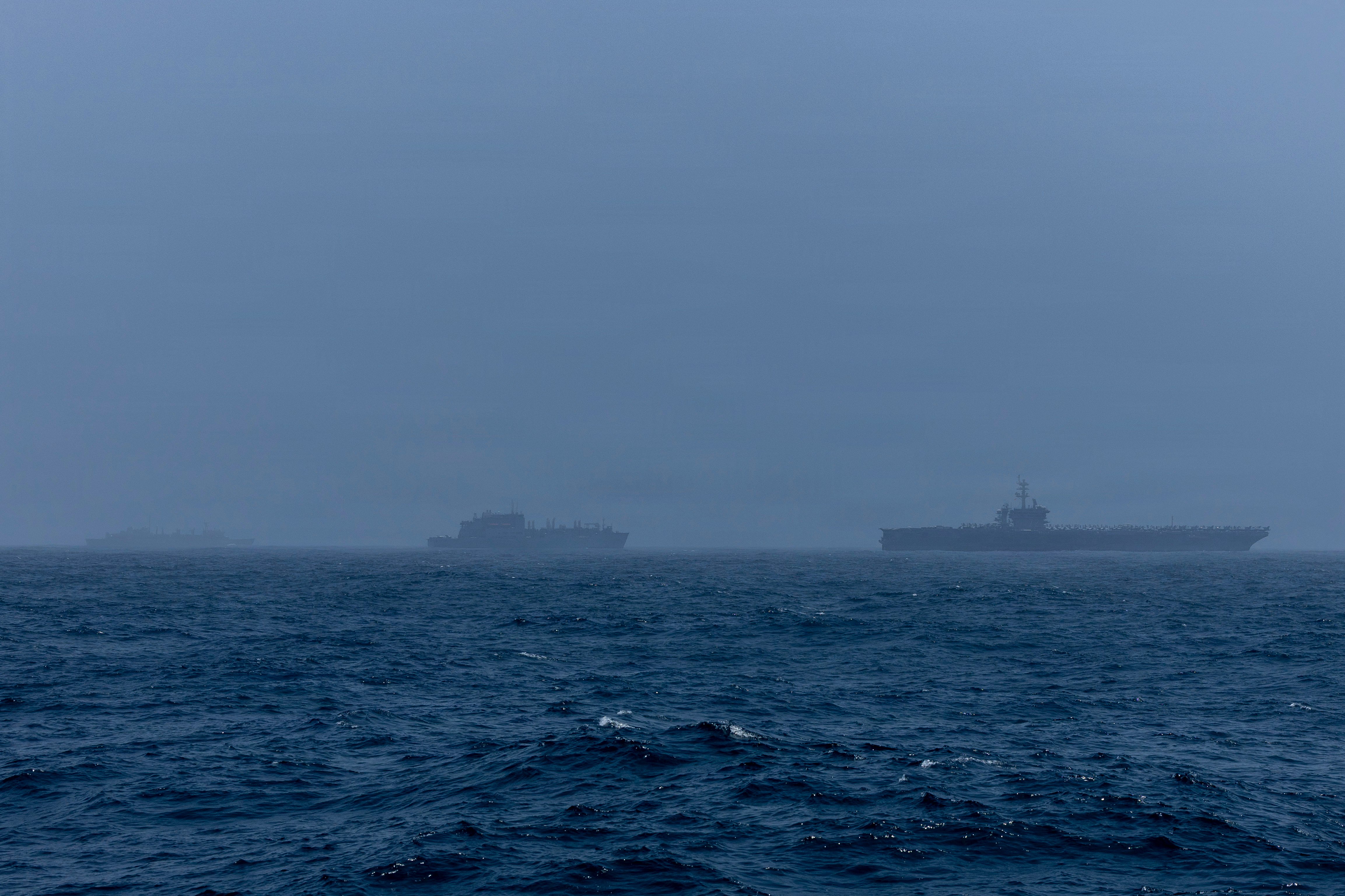 Nimitz-class aircraft carrier USS Abraham Lincoln (CVN 72), right, Supply-class fast combat support ship USNS Arctic (T-AOE 8), middle, and Lewis and Clark-class dry cargo ship USNS Alan Shepard (T-AKE-3) sail in the Arabian Sea, Aug. 16, 2026. Abraham Lincoln is deployed to the U.S. 5th Fleet area of operations to support maritime security and stability in the Middle East. (U.S. Navy photo)