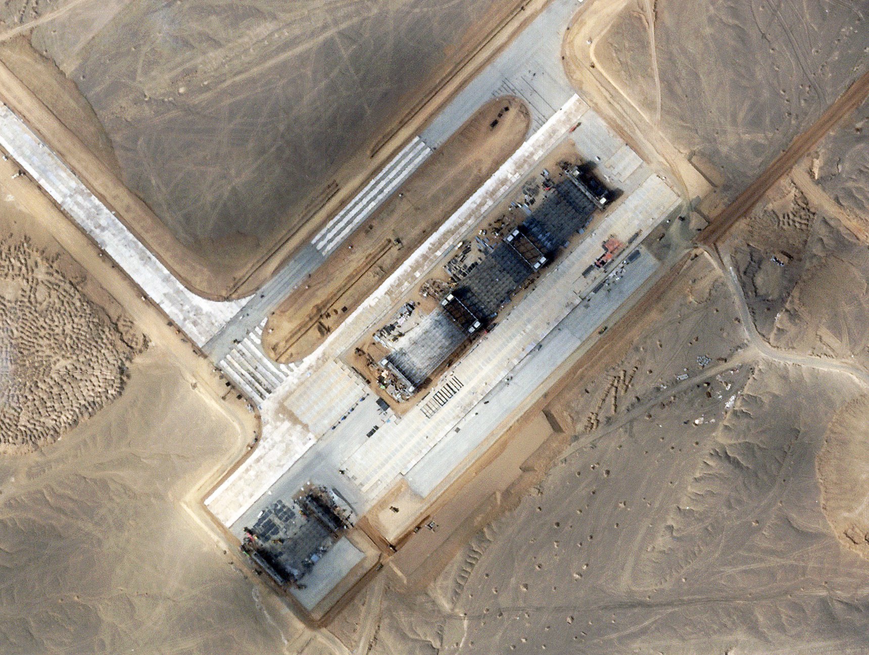 Close up shot of the four large, new hangars under construction below the southern part of the main runway.