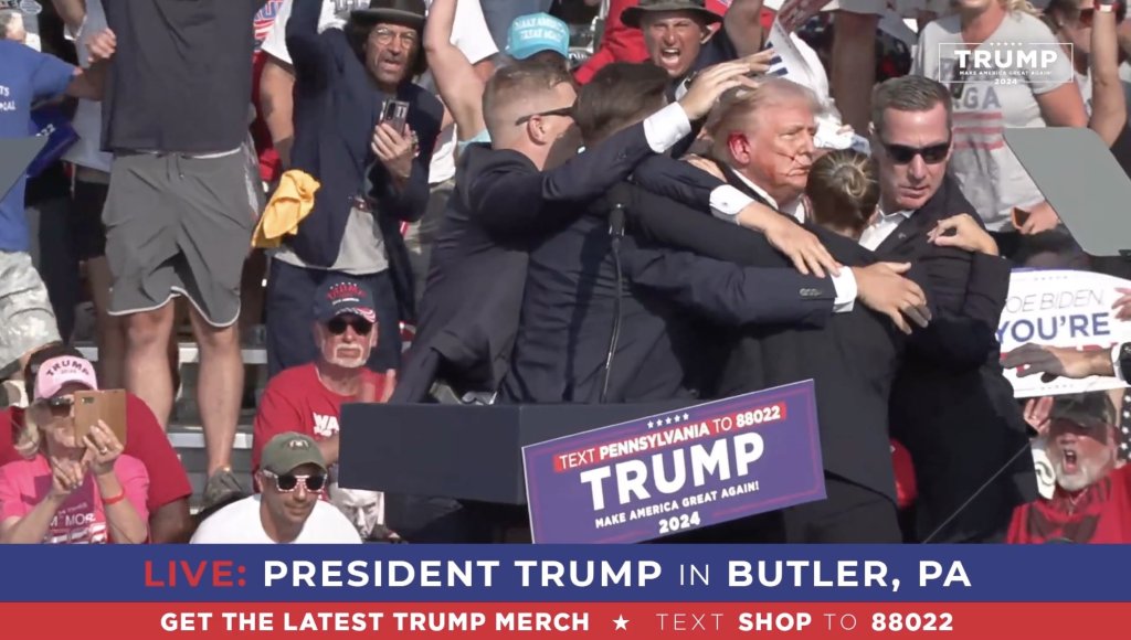 BUTLER, PENNSYLVANIA, UNITED STATES - JULY 13: (----EDITORIAL USE ONLY - MANDATORY CREDIT - 'TRUMP CAMPAIGN OFFICE / HANDOUT' - NO MARKETING NO ADVERTISING CAMPAIGNS - DISTRIBUTED AS A SERVICE TO CLIENTS----) A screen grab captured from a video shows Republican presidential candidate former President Donald Trump appears to be injured after gunshots were reported as he is rushed offstage during a rally on July 13, 2024 in Butler, Pennsylvania. Trump was seen bloodied on his right ear as he was being evacuated from the stage, according to social media footage. (Photo by Trump Campaign Office / Handout/Anadolu via Getty Images)