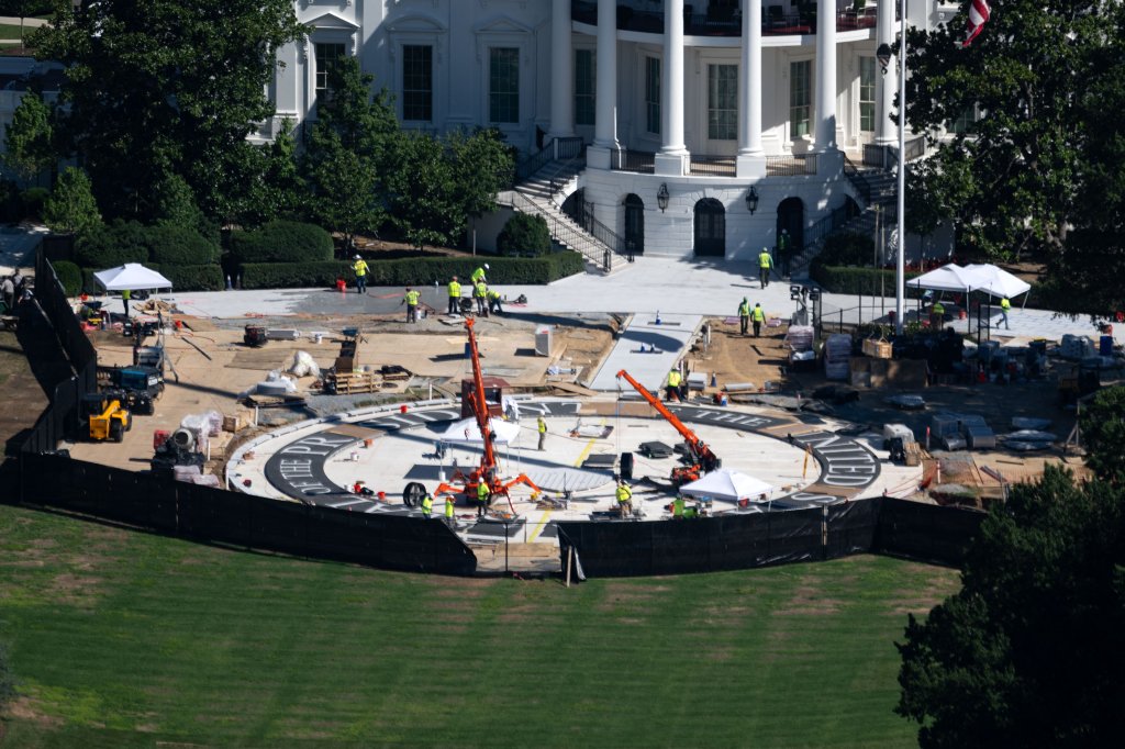Lettering spelling out "Seal of the President of the United States" is seen on the currently under construction helipad on the South Lawn of the White House in Washington, DC on July 30, 2026. The landing site aims to solve problems associated with the new fleet of presidential helicopters built by Sikorsky. (Photo by Kent Nishimura / AFP via Getty Images)