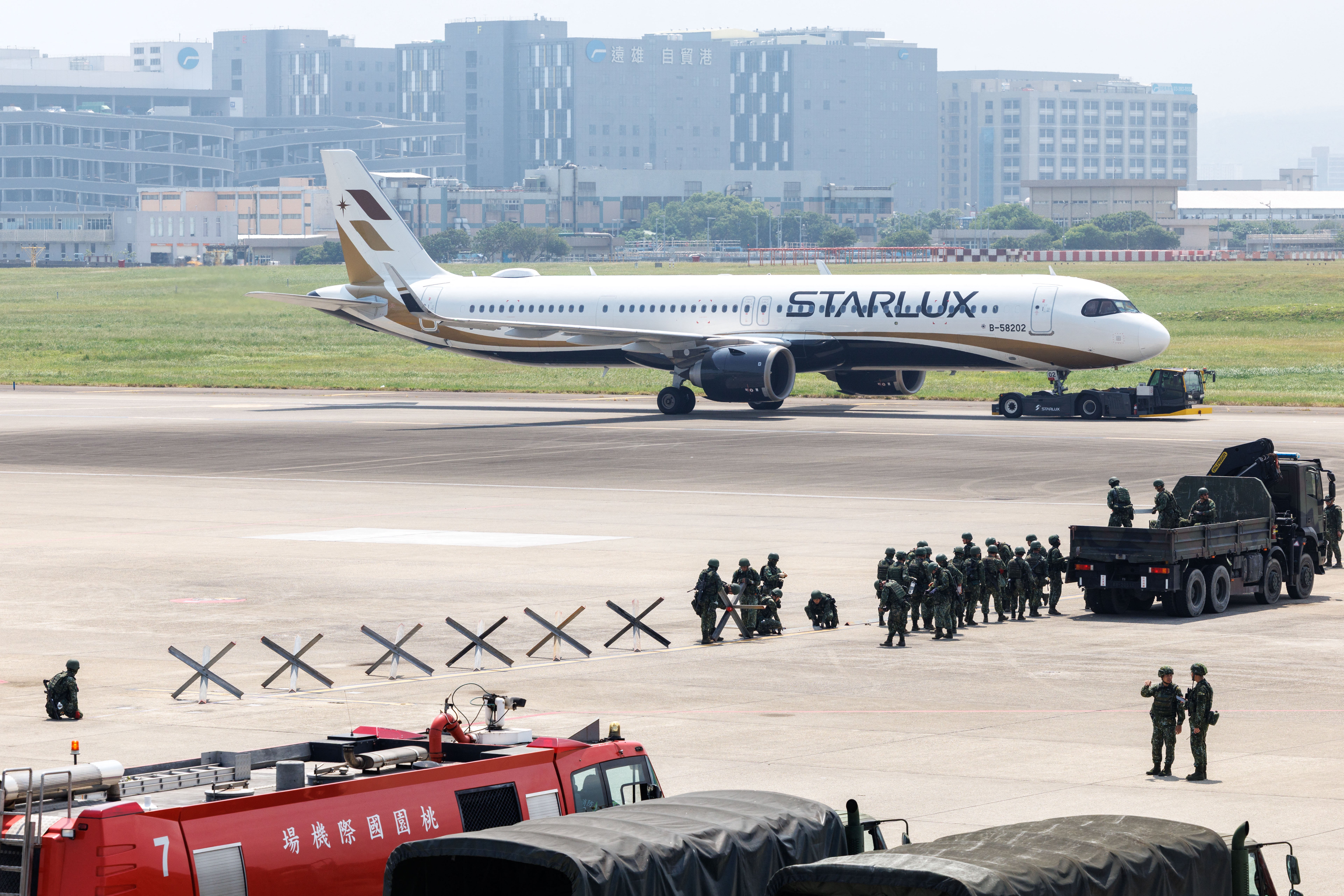 Taiwanese soldiers set up defensive obstacles during a civil-military drill simulating an enemy airborne assault at Taiwan Taoyuan International Airport in Taoyuan on August 7, 2026. Taiwan's largest military drills of the year began on August 5 as the island democracy attempts to prepare its population for a potential Chinese invasion. (Photo by CHENG Yu-chen / AFP via Getty Images)