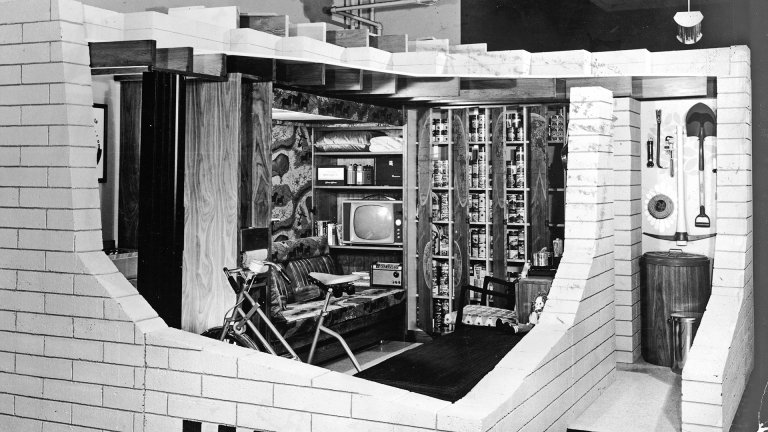 Cutaway display of a concrete masonry basement fallout shelter with an exercise bike, television and library, 1950s. (Photo by Pictorial Parade/Getty Images)