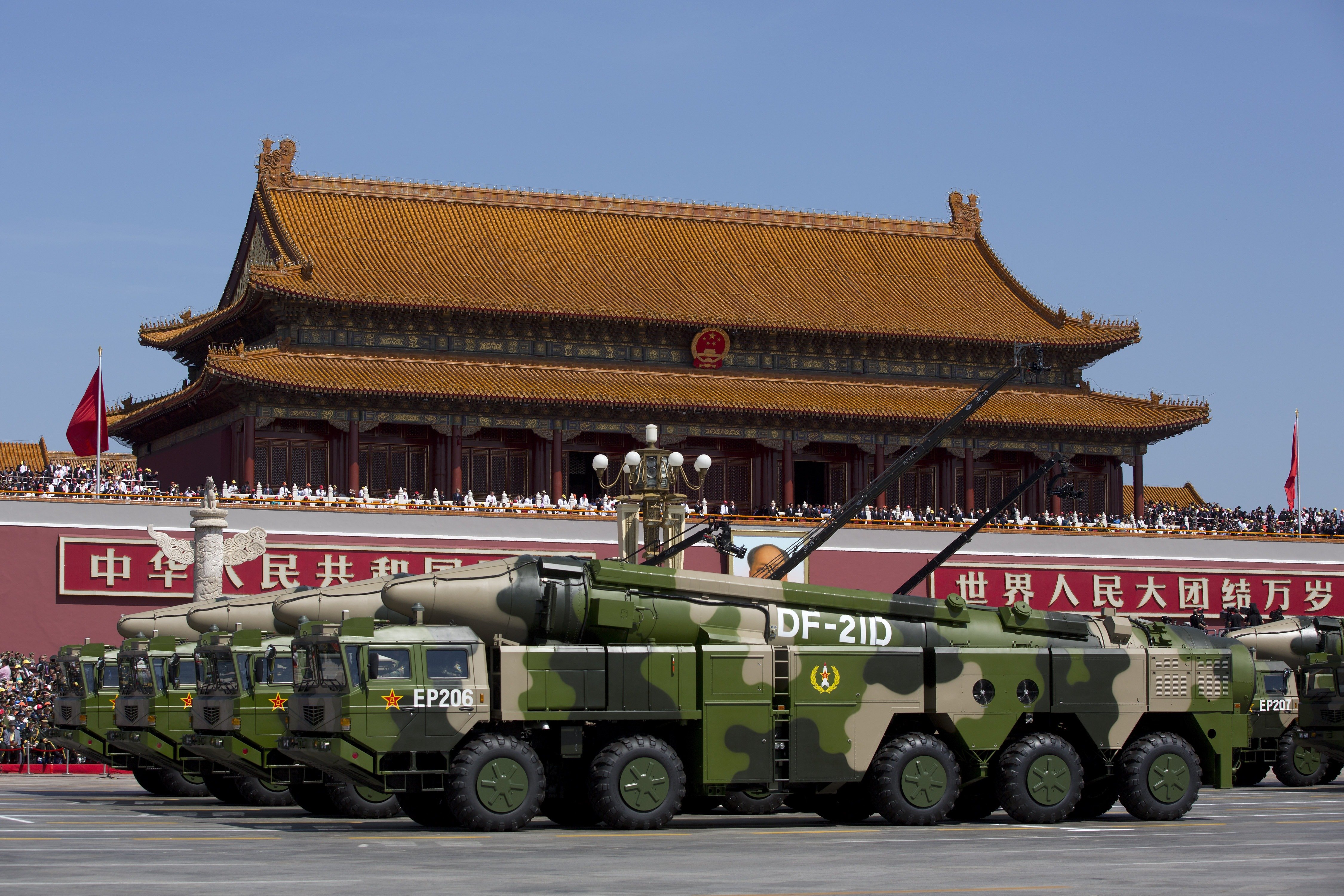 BEIJING, CHINA - SEPTEMBER 03: Chinese military vehicles carrying DF-21D anti-ship ballistic missiles, potentially capable of sinking a U.S. Nimitz-class aircraft carrier in a single strike, drive past the Tiananmen Gate during a military parade to mark the 70th anniversary of the end of World War Two on September 3, 2015 in Beijing, China. China is marking the 70th anniversary of the end of World War II and its role in defeating Japan with a new national holiday and a military parade in Beijing. (Photo by Andy Wong - Pool /Getty Images)