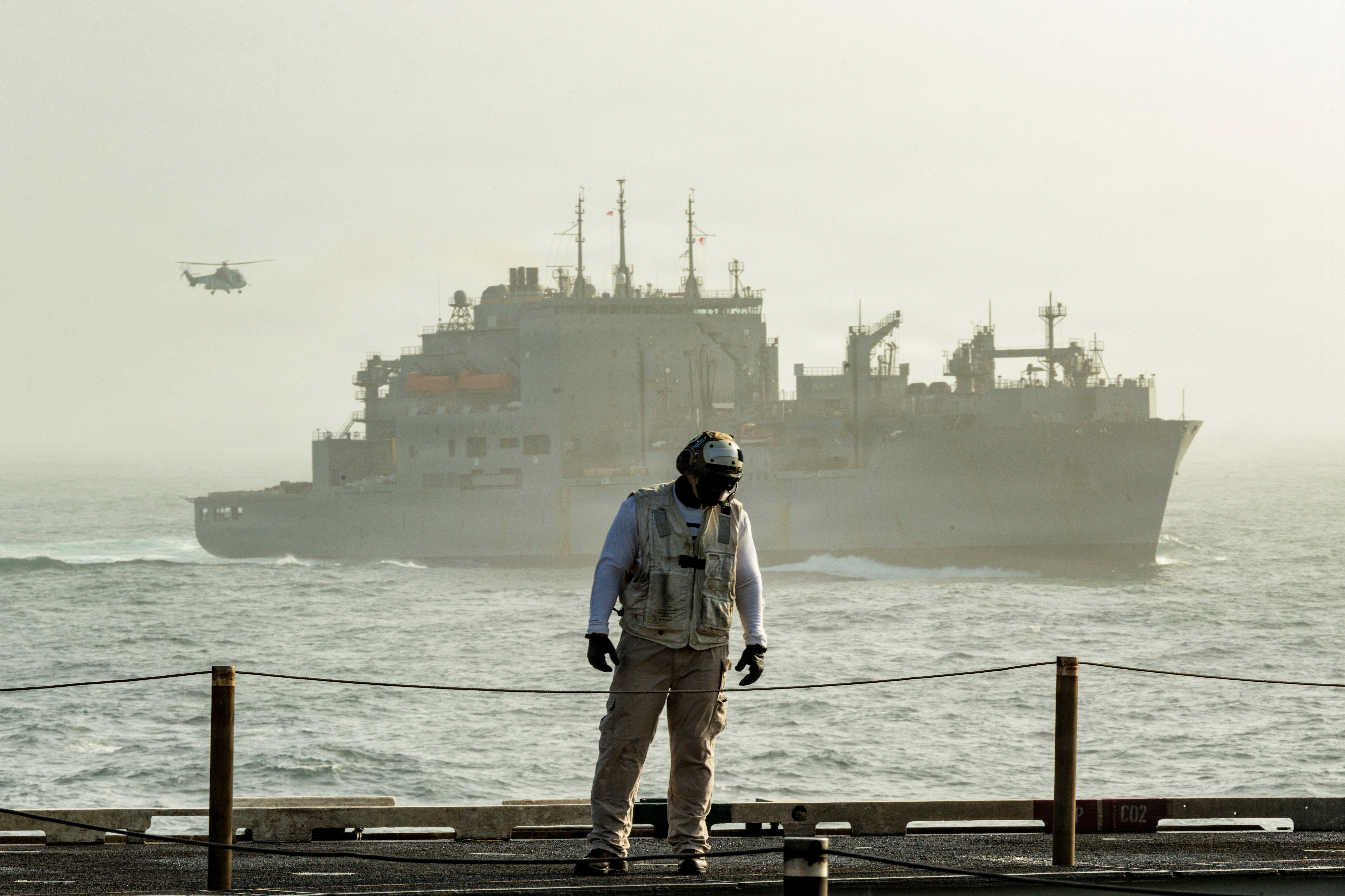 A U.S. Navy Sailor participates in a replenishment-at-sea evolution aboard Nimitz-class aircraft carrier USS George Washington (CVN 73) in the Arabian Sea, Aug. 22, 2026. George Washington is deployed to the U.S. 5th Fleet area of operations to support maritime security and stability in the Middle East. (U.S. Navy photo)