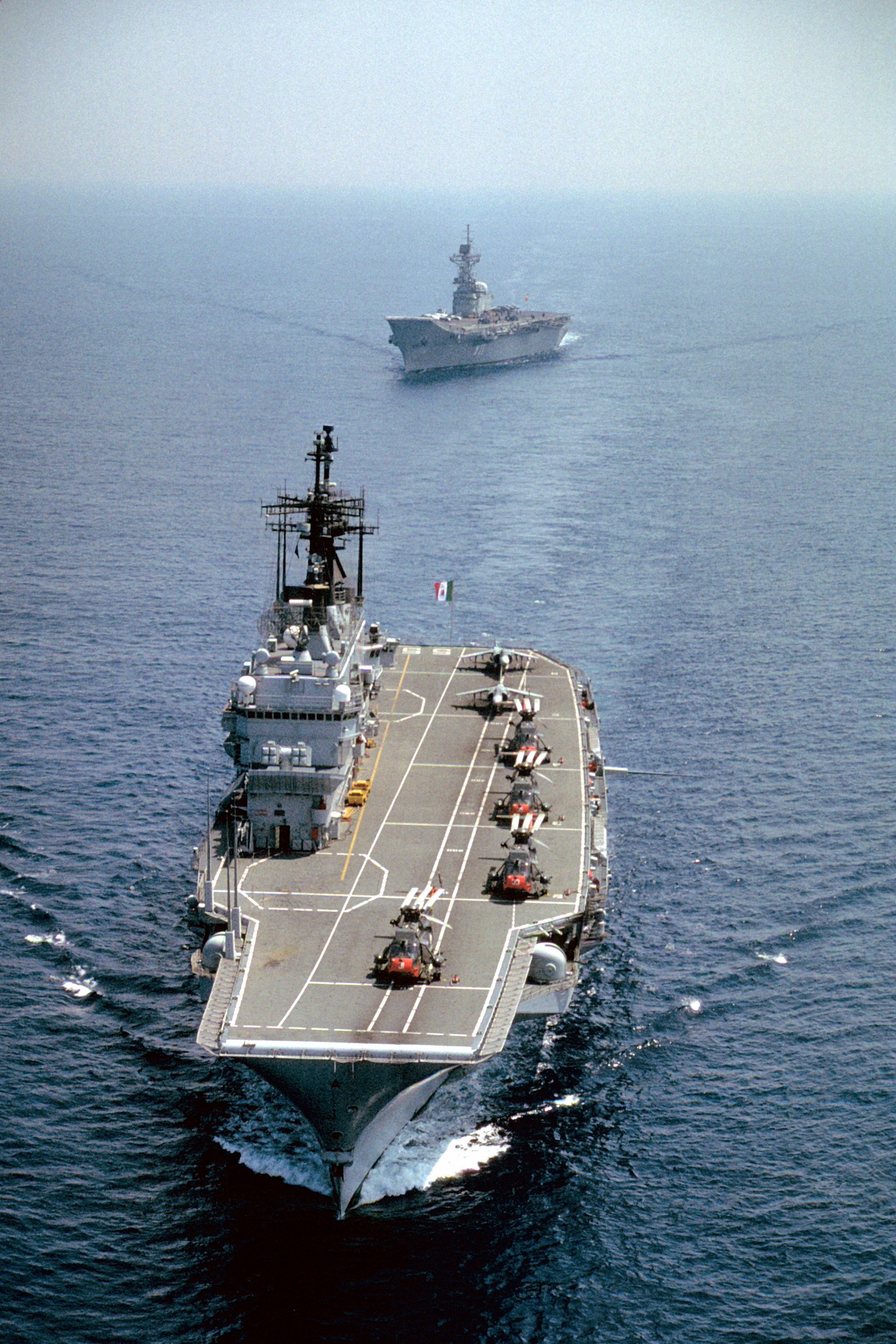 The Spanish navy's aircraft carrier PRINCIPE DE ASTURIAS (R-11) follows the Italian navy's aircraft carrier GUISEPPE GARIBALDI (C-551) as the two vessels take part in the joint exercise Dragon Hammer '92.