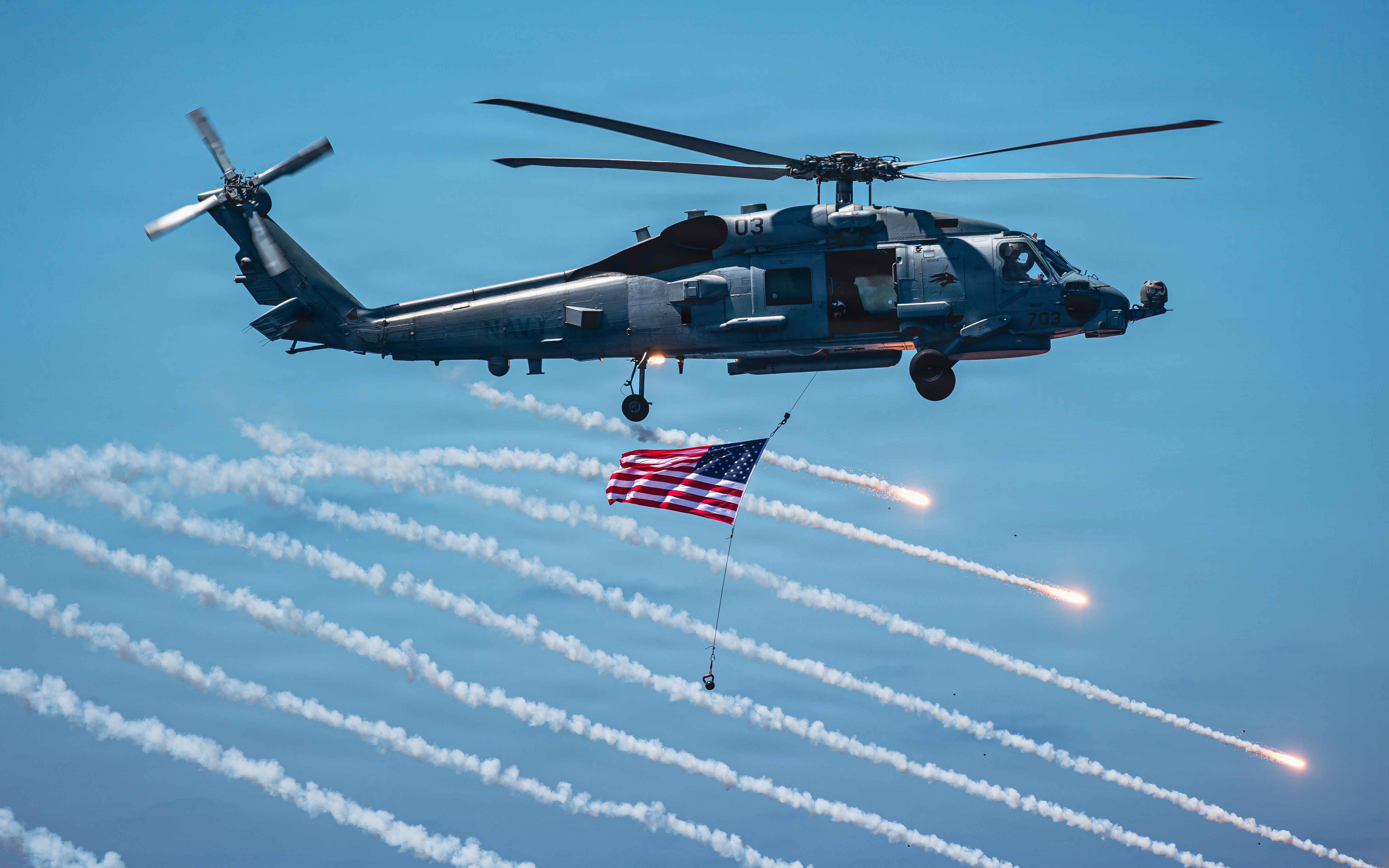 U.S. Navy MH-60R Seahawk helicopter, assigned to Helicopter Maritime Strike Squadron (HSM) 75, shoots flares while flying over the flight deck of Nimitz-class aircraft carrier USS Theodore Roosevelt (CVN) 71 during a friends and family day cruise, Aug. 8, 2026. Theodore Roosevelt’s friends and family day cruise showcases carrier strike group capabilities and the professionalism of the crew. (U.S. Navy photo by Mass Communication Specialist Seaman Tyler Harstad)