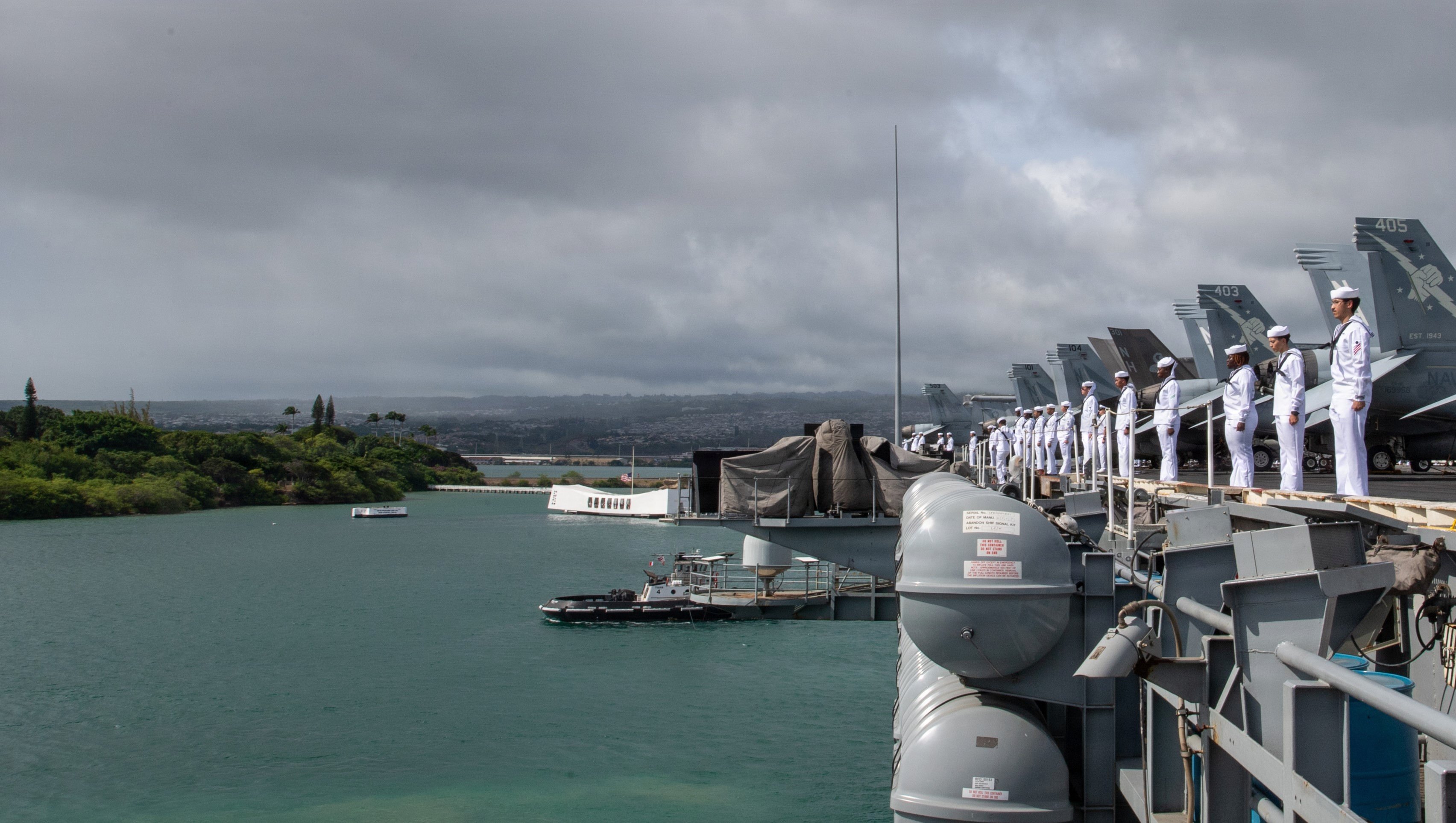 U.S. Navy Sailors, assigned to Nimitz-class aircraft carrier USS Theodore Roosevelt (CVN 71), man the rails as the ship passes the USS Arizona memorial while departing Joint Base Pearl Harbor-Hickman, Aug. 1, 2026. Theodore Roosevelt, flagship of Carrier Strike Group (CSG) 9, is underway operating in the U.S. 3rd Fleet area of operations. (U.S. Navy photo by Mass Communication Specialist 3rd Class Alexia Mezick)