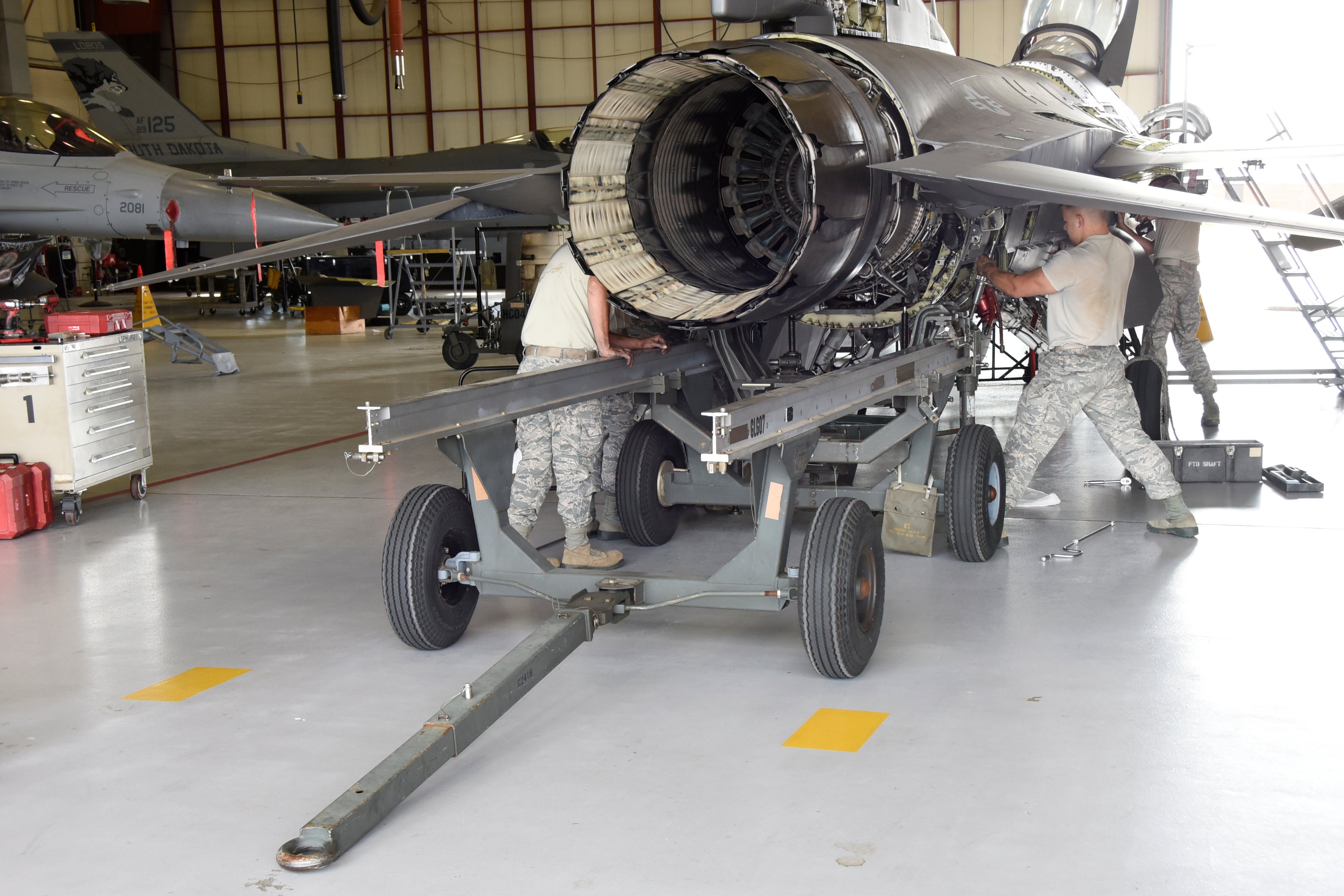 114th Aircraft Maintenance Squadron engine shop Airmen remove the engine of an F-16 during the De-paneling Phase of a phase maintenance inspection at Joe Foss Field, July 8, 2017. Each aircraft is required to go through a phase inspection every 400 flight hours to ensure all systems are functioning within Air Force regulations. (U.S. Air National Guard photo by Master Sgt. Christopher Stewart/Released)