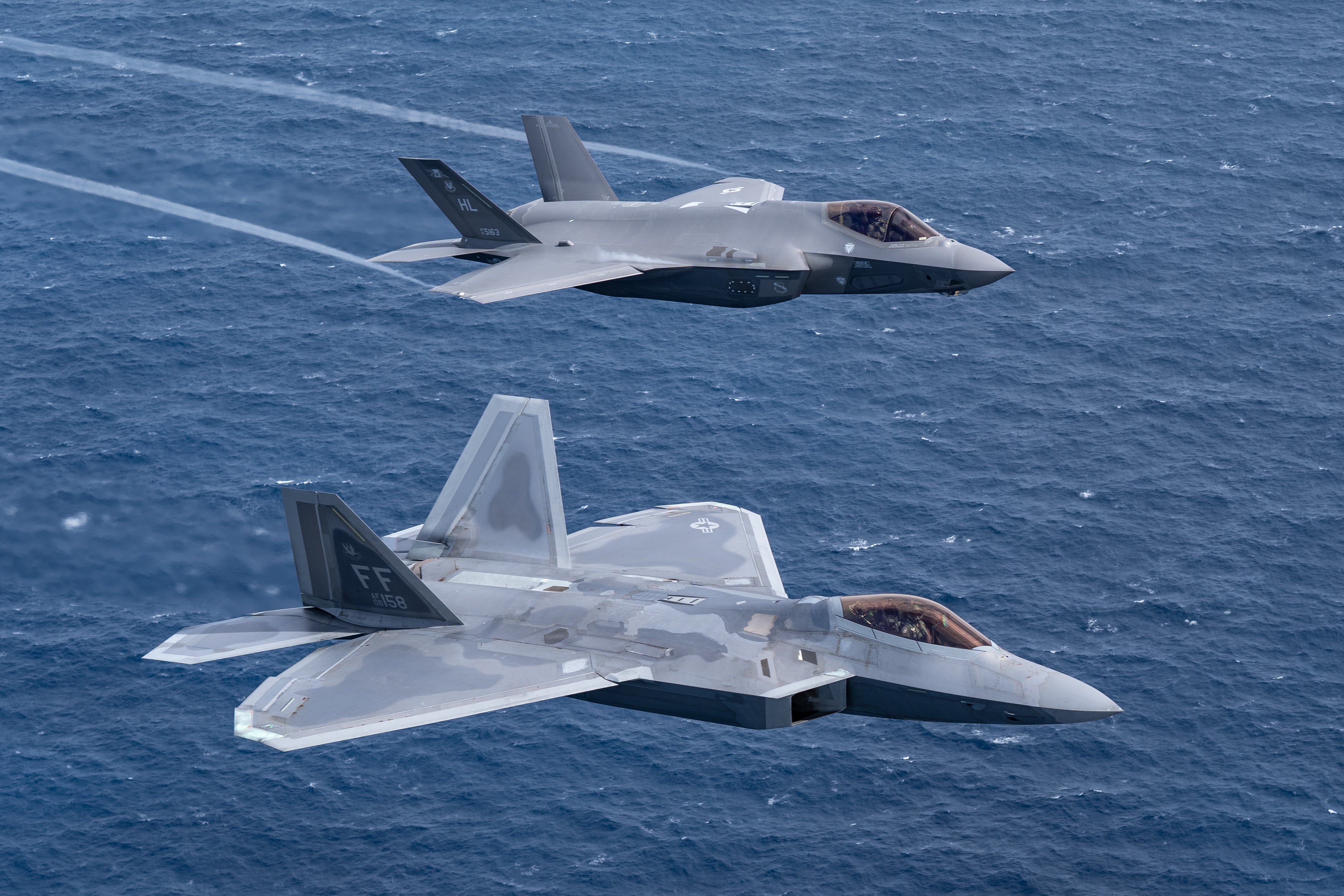 A U.S. Air Force F-22 Raptor flies alongside an F-35 Lightning II during a special formation flight in Fort Lauderdale, Fla. Nov. 20, 2020. These two 5th-generation aircraft represent the Air Force’s stealth fighter capability and perform a variety of air-to-air and air-to-ground mission. (U.S. Air Force photo by Lt. Sam Eckholm)