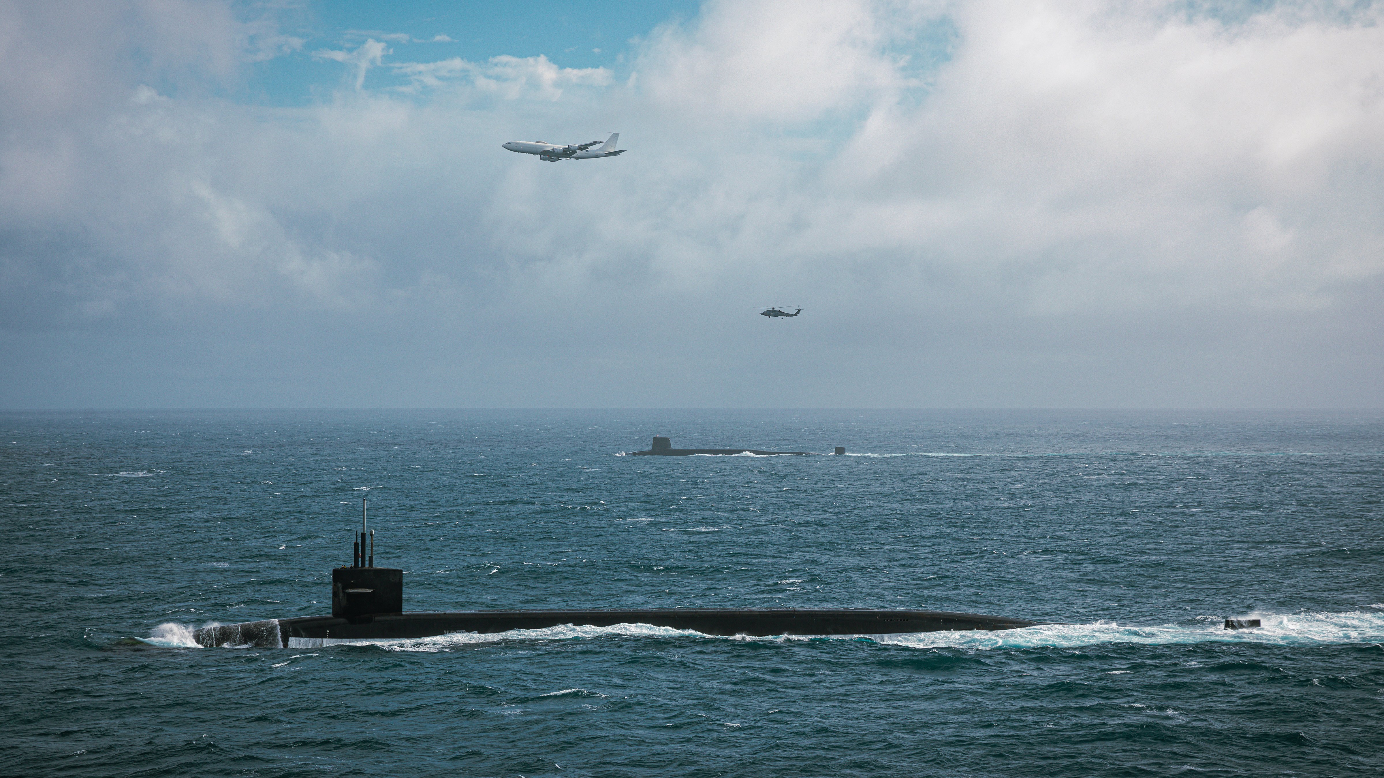U.S. Navy Ohio-class ballistic missile submarine USS Tennessee (SSBN 734), an United Kingdom Royal Navy Vanguard-class nuclear submarine, an E6-B Mercury assigned to the "Shadows" of Fleet Air Reconnaissance Squadron (VQ) 4 and an MH60R Sea Hawk helicopter attached to the “Proud Warriors” of Helicopter Maritime Strike Squadron (HSM) 72 conducted bi-lateral at sea training designed to validate tactics, techniques, and procedures which strengthens the relationship between uniquely close Allies in support of deterrence and collective security. The United States and the United Kingdom have a long-standing agreement of cooperation in the development and deployment of strategic weapons and supporting system. (U.S. Navy photo by Naval Aircrewman (Operator) 1st Class Aaron Abbott/Released)