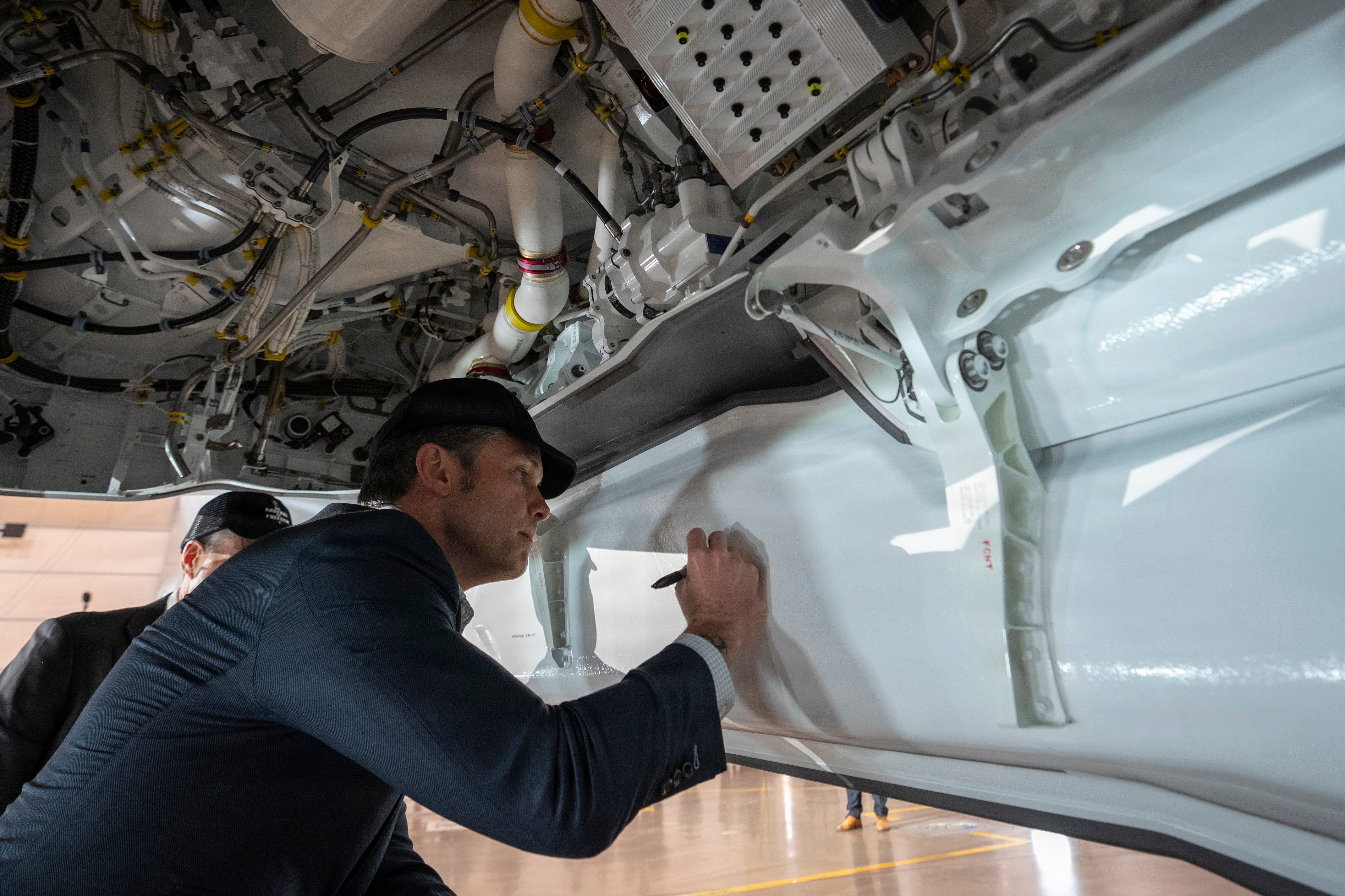 Secretary of War Pete Hegseth autographs the weapons bay of an F-35 Lightning II at Lockheed Martin Air Force Plant 4, as part of his Arsenal of Freedom Tour, Fort Worth, Texas, Jan. 12, 2025. (DoW photo by U.S. Navy Petty Officer 1st Class Alexander Kubitza)
