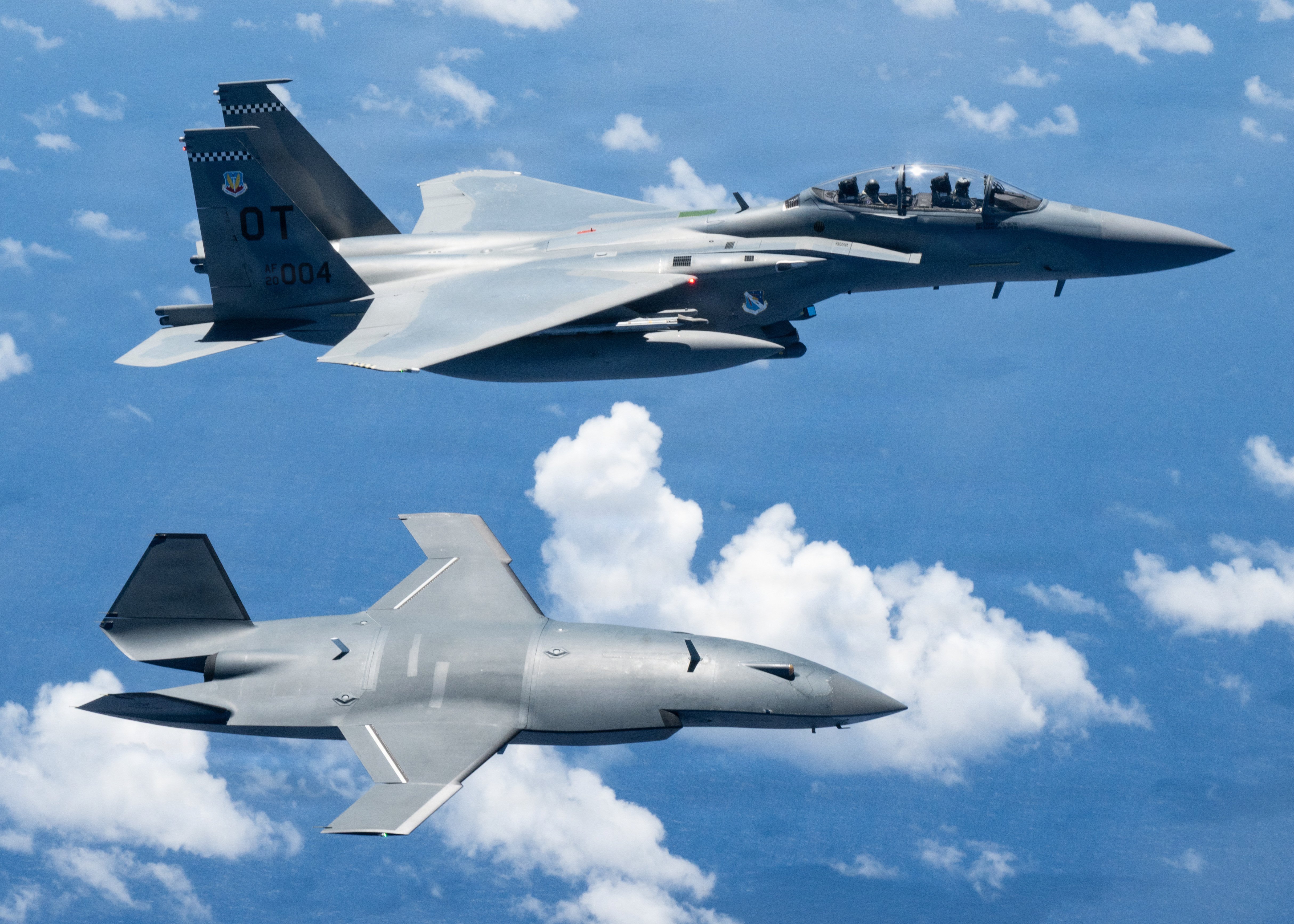 An MQ-28 Ghost Bat from Boeing Defense Australia and a U.S. Air Force F-15EX Eagle II, assigned to the 85th Test and Evaluation Squadron participate in Valiant Shield 2026 over the Philippine Sea, June 27, 2026. Exercises like Valiant Shield allow U.S. Pacific Command to integrate forces from all branches of service along with our allies to conduct precise, lethal, and overwhelming multi-axis, multi-domain effects that demonstrate our capabilities and commitment to a free and open Indo-Pacific. (U.S. Air Force photo by Tech Sgt. Thomas Barley)
