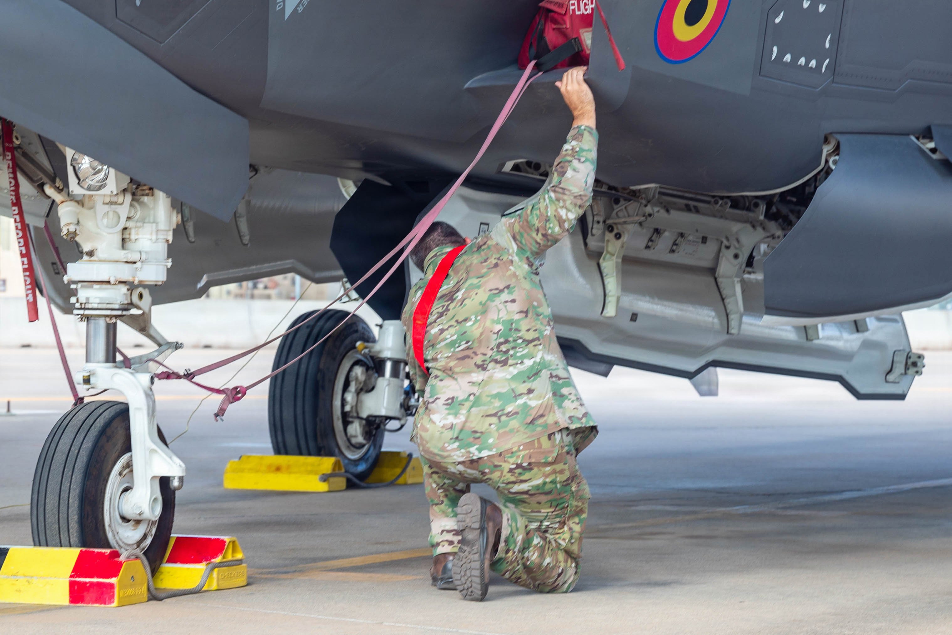 A Belgian Air Force service member stationed at Luke Air Force Base inspects the weapons bay of an F-35A Lightning II at Luke AFB, Arizona, Aug. 12, 2026. Integrated maintenance operations with Allied and partner forces strengthen readiness and mutual interoperability, ensuring combat-ready forces are prepared to outpace evolving global threats. (U.S. Air Force photo by Airman 1st Class Tekorey Watkins)