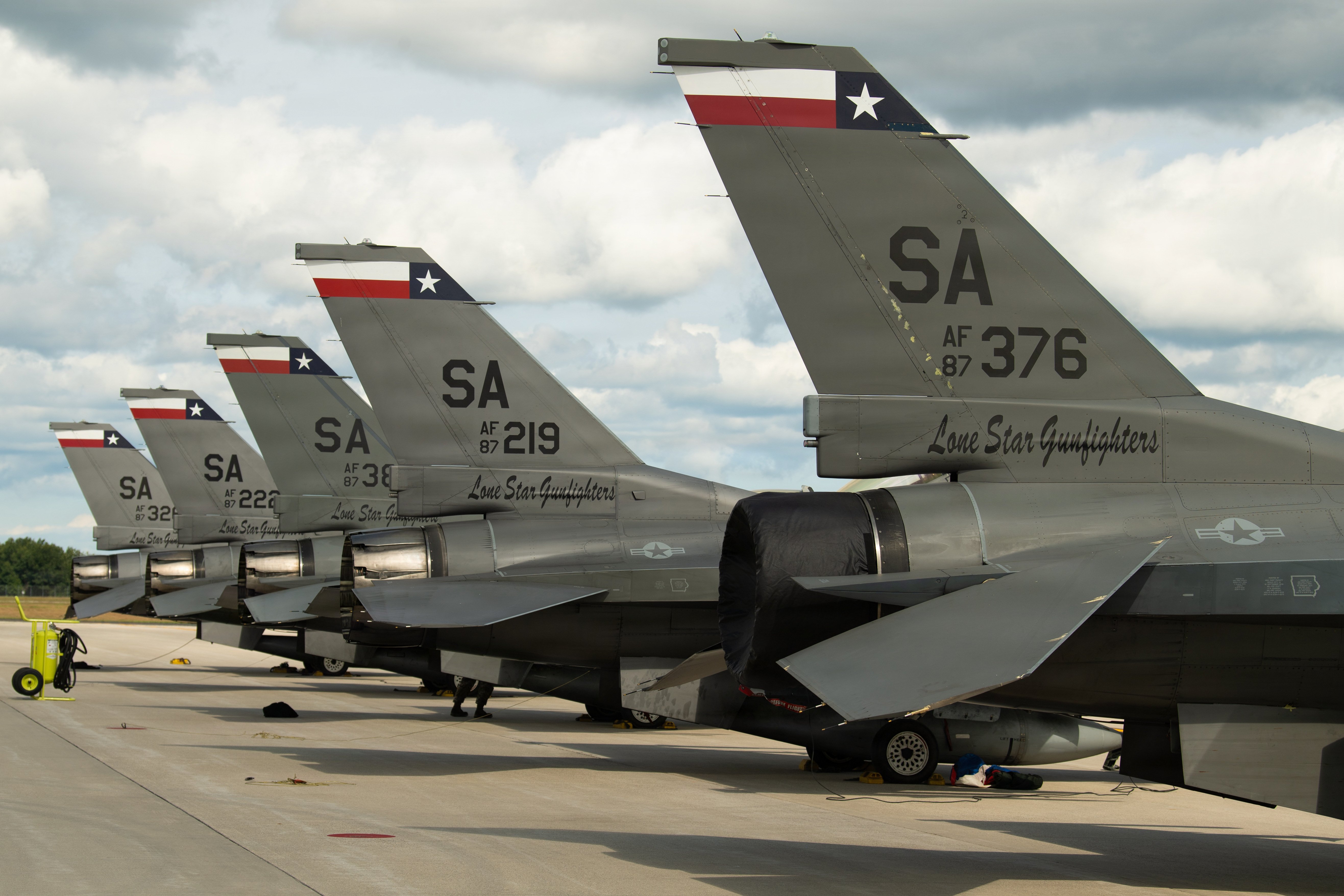 A formation of F-16 Fighting Falcons sit along the flightline during Operation Northern Cactus at Alpena Combat Readiness Training Center (CRTC), Mich., September 13, 2026. Northern Cactus tests the 149th Fighter Wing’s ability to deploy personnel and equipment, establish operations at an unfamiliar location, and accomplish mission objectives away from home station. (Air National Guard photo by Airman 1st Class Jonathan Rasco)