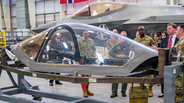 The Honorable Michael Duffey (center right), Under Secretary of War for acquisition and sustainment, discusses the canopy of an F-35A Lighting II with 56th Fighter Wing Airmen, Jan. 21, 2026, at Luke Air Force Base, Arizona. Luke Airmen execute operational support functions that enable the safe and effective training of future F-35 pilots. Their professionalism and repeatable execution ensure consistent standards that translate into readiness across the force.